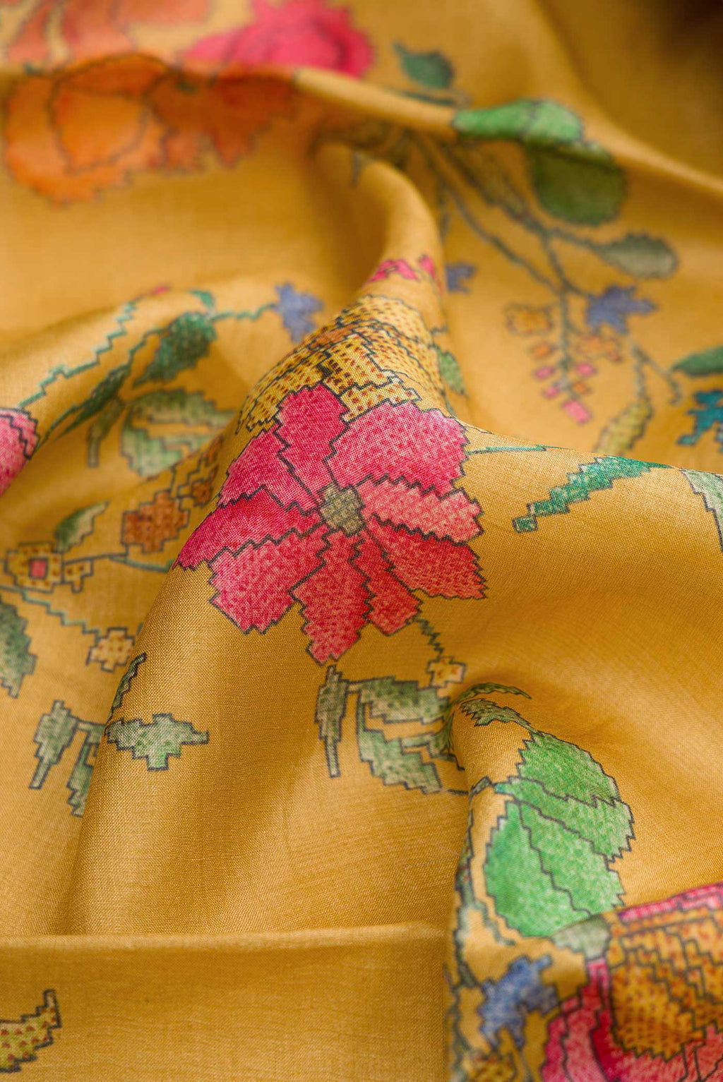 Close up of Mustard Dual Tone Tussar Silk Saree with Printed design on the body and Zari Border displaying folds