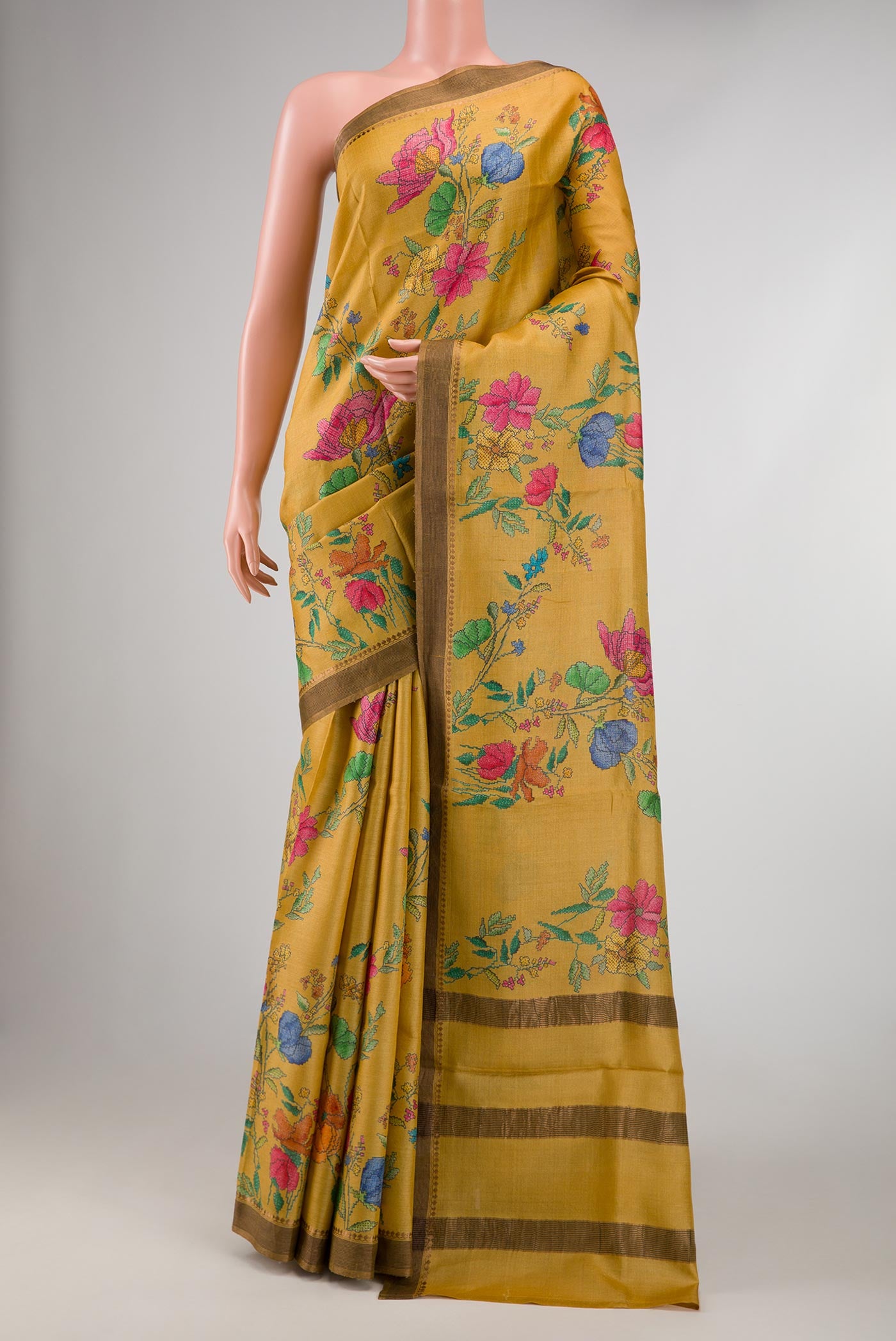 Mustard Dual Tone Tussar Silk Saree with Printed design on the body and Zari Border displayed on a mannequin