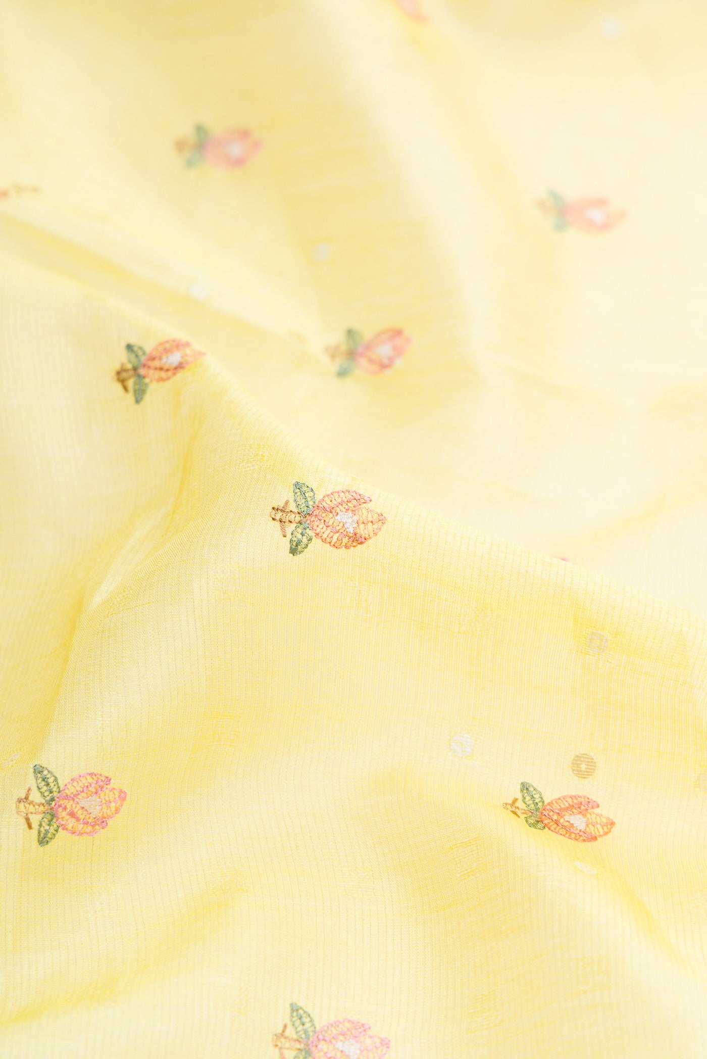 Close up of Lemon Yellow Dual Tone Tussar Silk Saree with Embroidery on the body and Fancy Border.  displaying folds