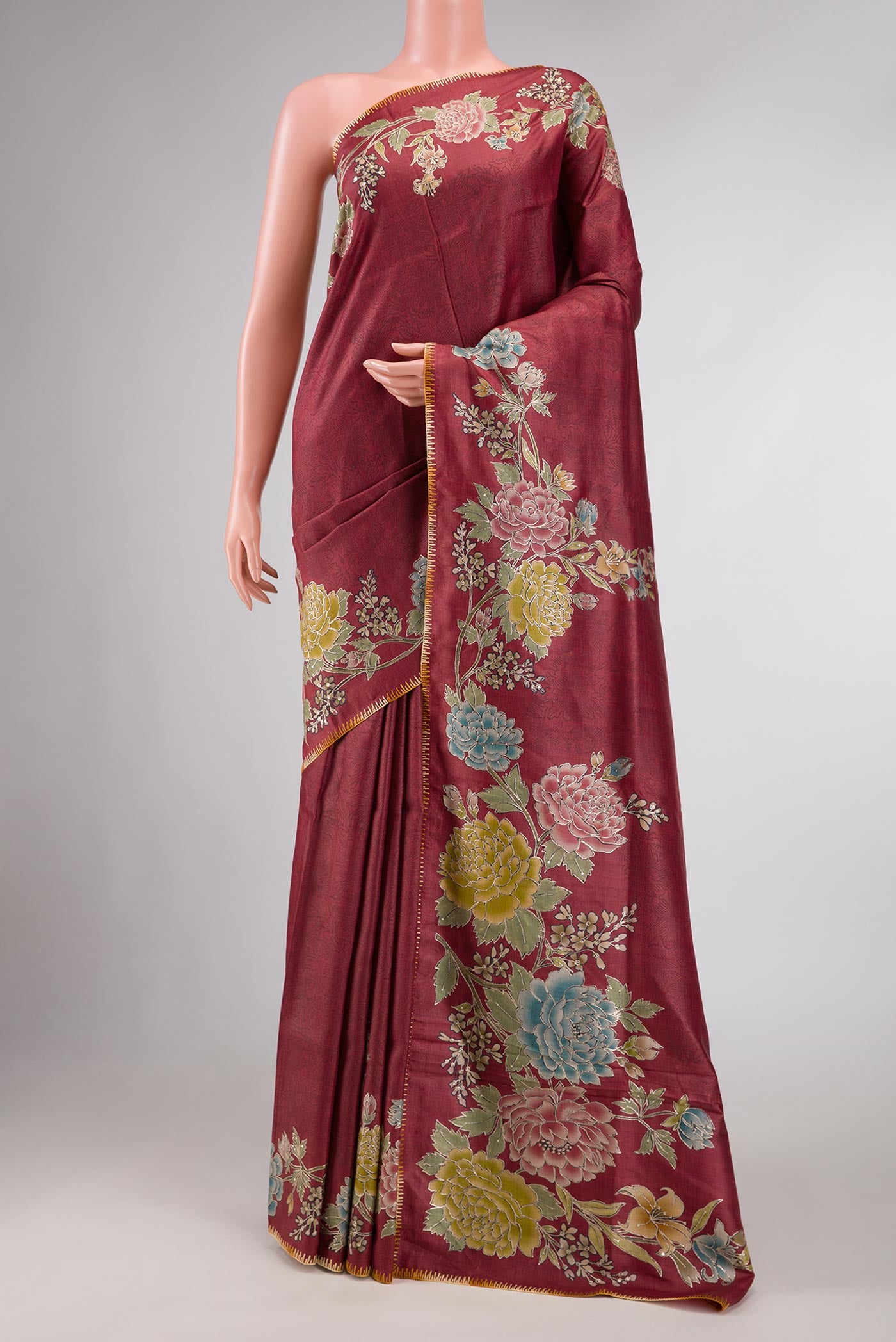 Maroon Tussar Silk Saree with Floral Print on the body and Embroidery Border displayed on a mannequin
