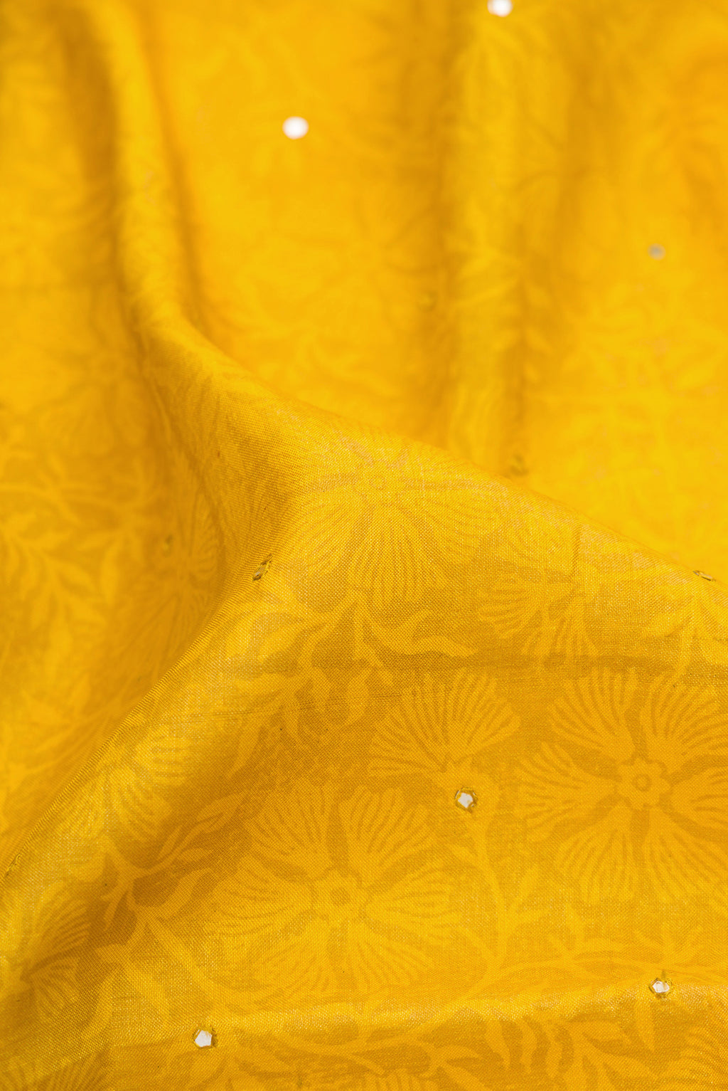 Close up of Mustard Dual Tone Tussar Silk Saree with Embroidery on the body and Embroidery Border.  displaying folds
