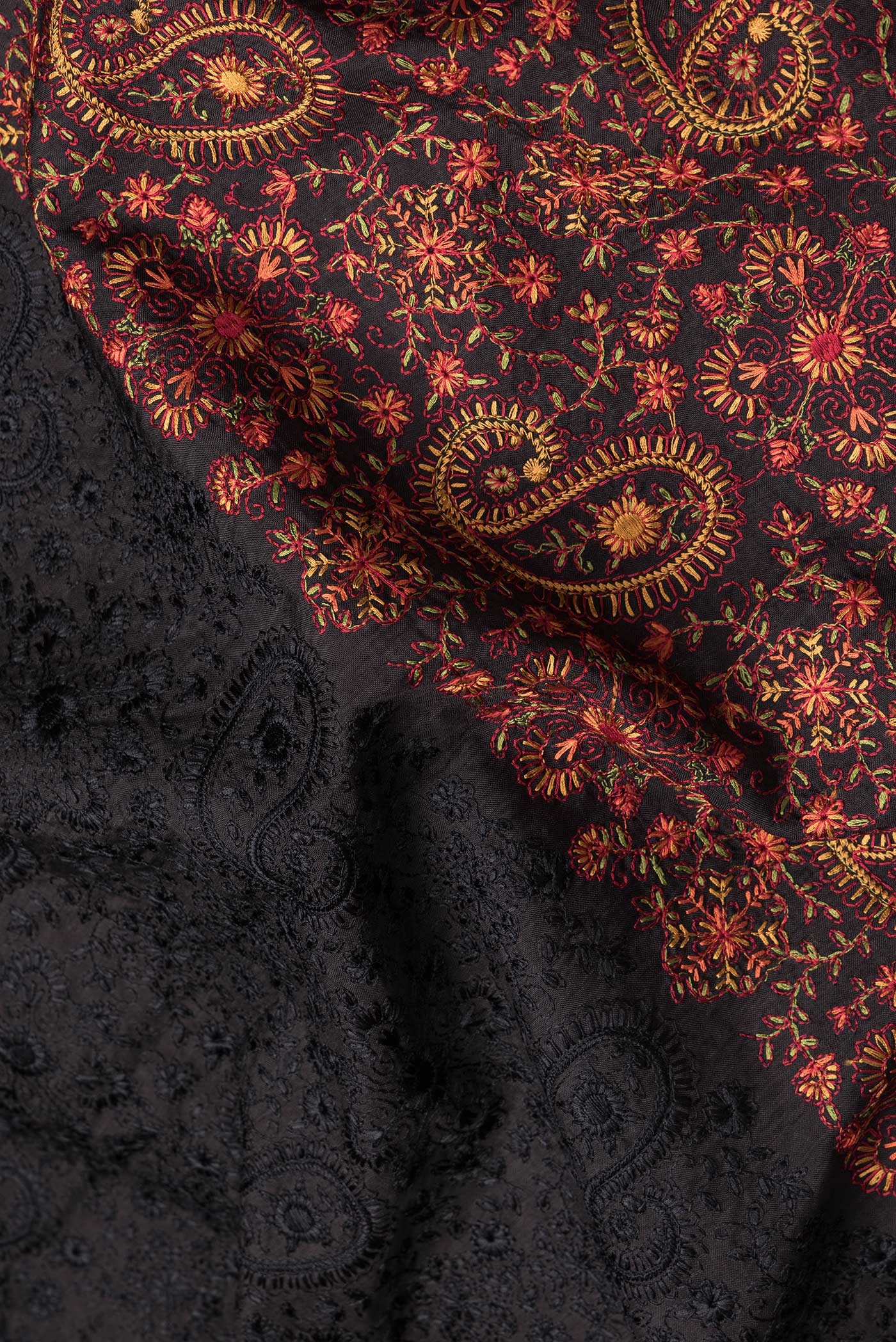 Close up of Black Dual Tone Tussar Silk Saree with Embroidery on the body and Zari Border.  displaying folds
