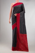 Black Dual Tone Double Ikat Saree with Ikat Print on the body and Plain Border displayed on a mannequin