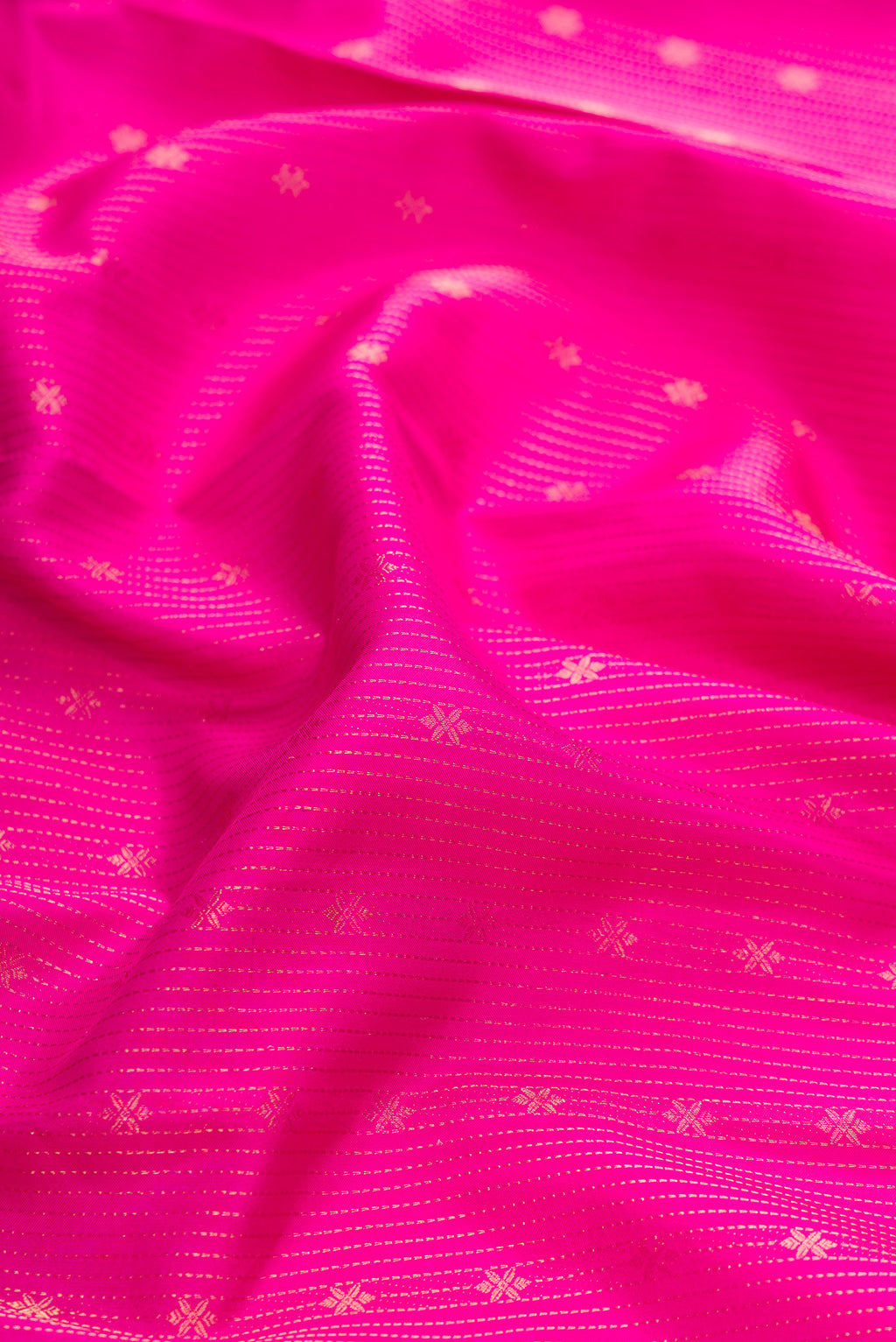 Close up of Pink Dual Tone Kanchipuram Silk Saree with Stripes on the body and Zari Border.  displaying folds