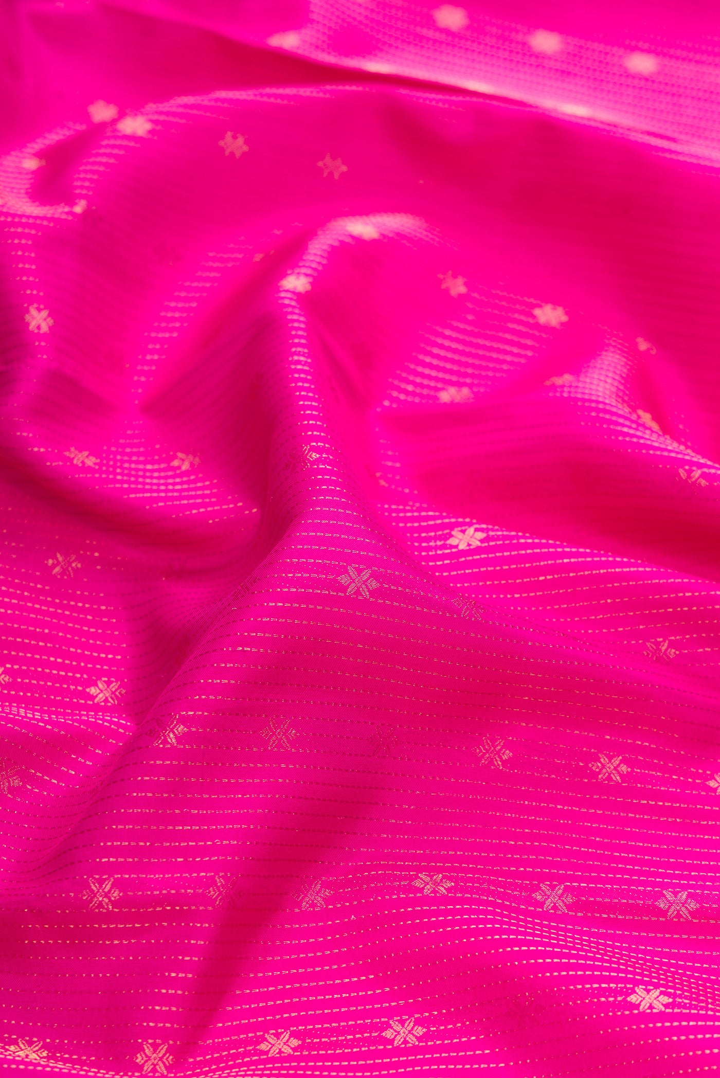 Close up of Pink Dual Tone Kanchipuram Silk Saree with Stripes on the body and Zari Border.  displaying folds