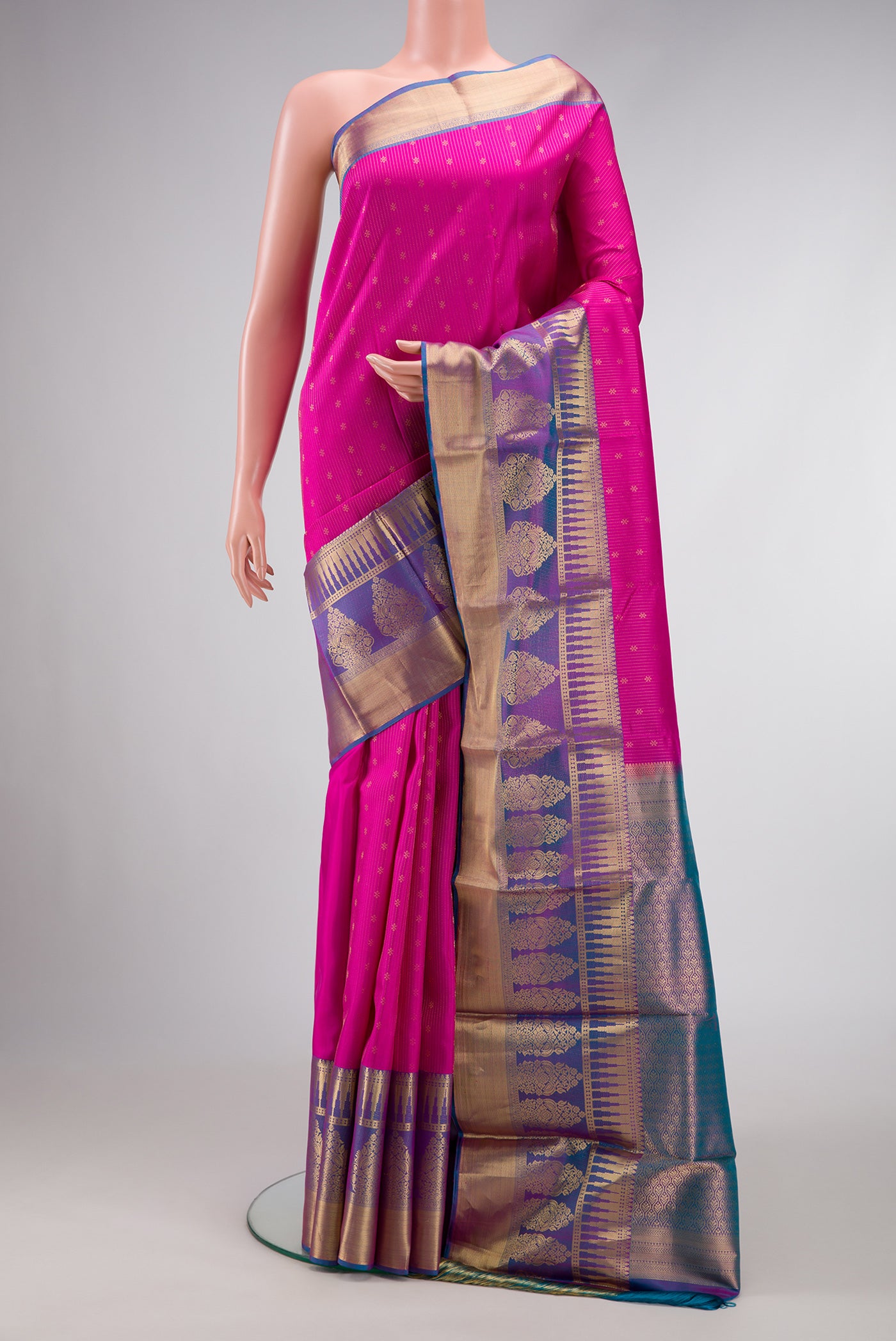 Pink Dual Tone Kanchipuram Silk Saree with Stripes on the body and Zari Border.  displayed on a mannequin