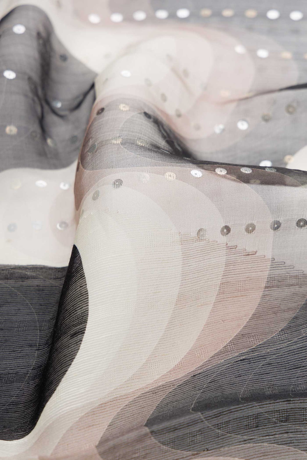 Close up of Black Dual Tone Tussar Silk Saree with Embroidery on the body and Without Border displaying folds