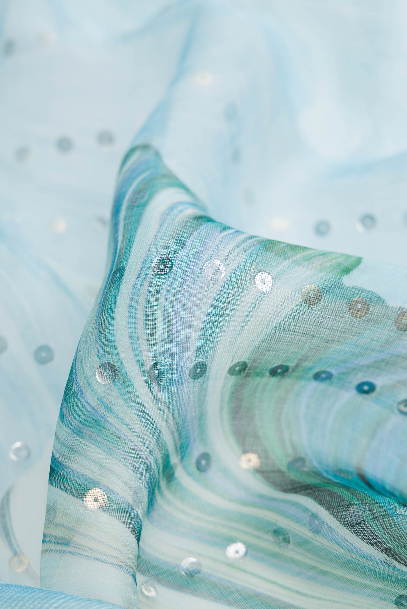 Close up of Light Blue Dual Tone Tussar Silk Saree with Embroidery on the body and Without Border displaying folds