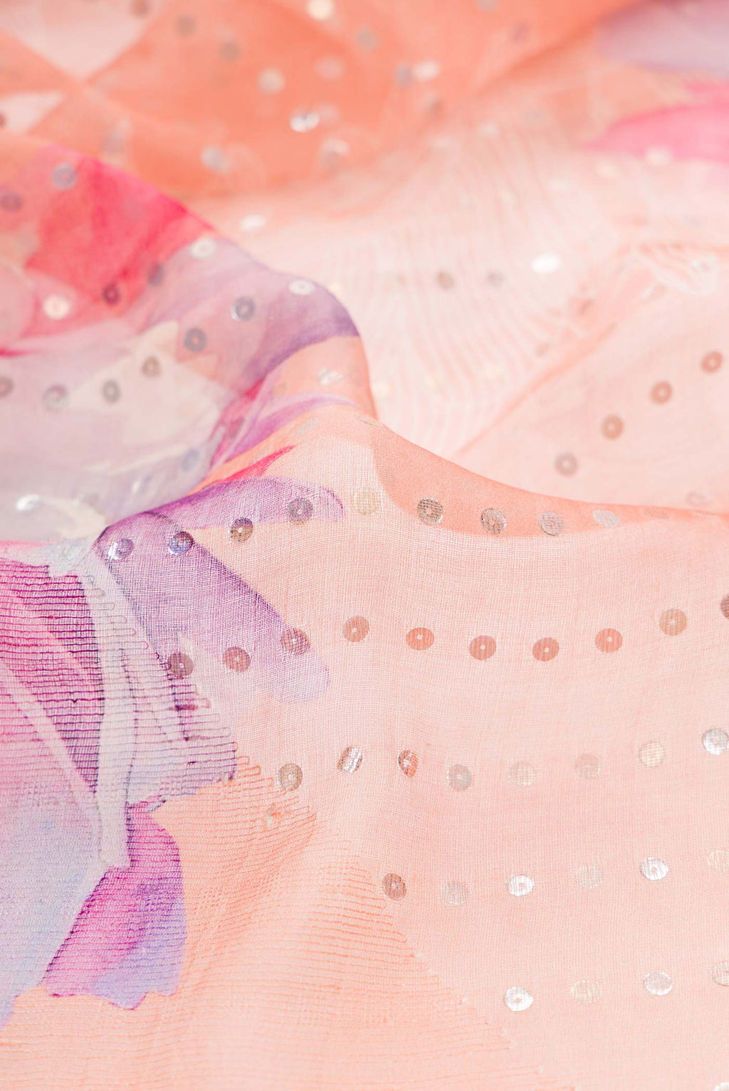 Close up of Peach Dual Tone Tussar Silk Saree with Embroidery on the body and Embroidery Border displaying folds
