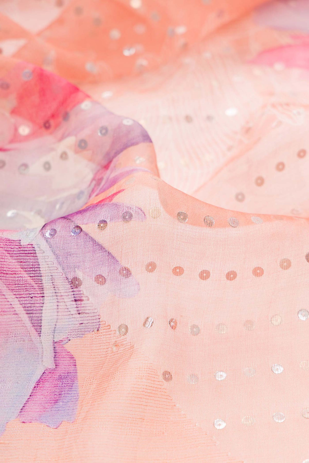 Close up of Peach Dual Tone Tussar Silk Saree with Embroidery on the body and Embroidery Border displaying folds