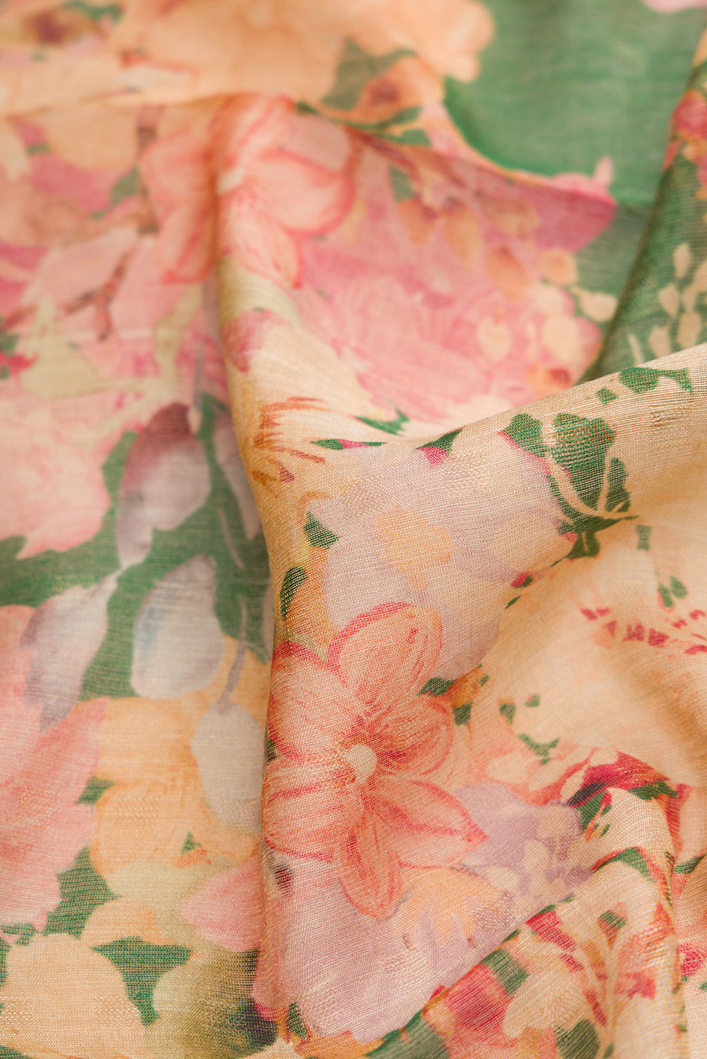 Close up of Green Dual Tone Tussar Silk Saree with Printed design on the body and Embroidery Border.  displaying folds
