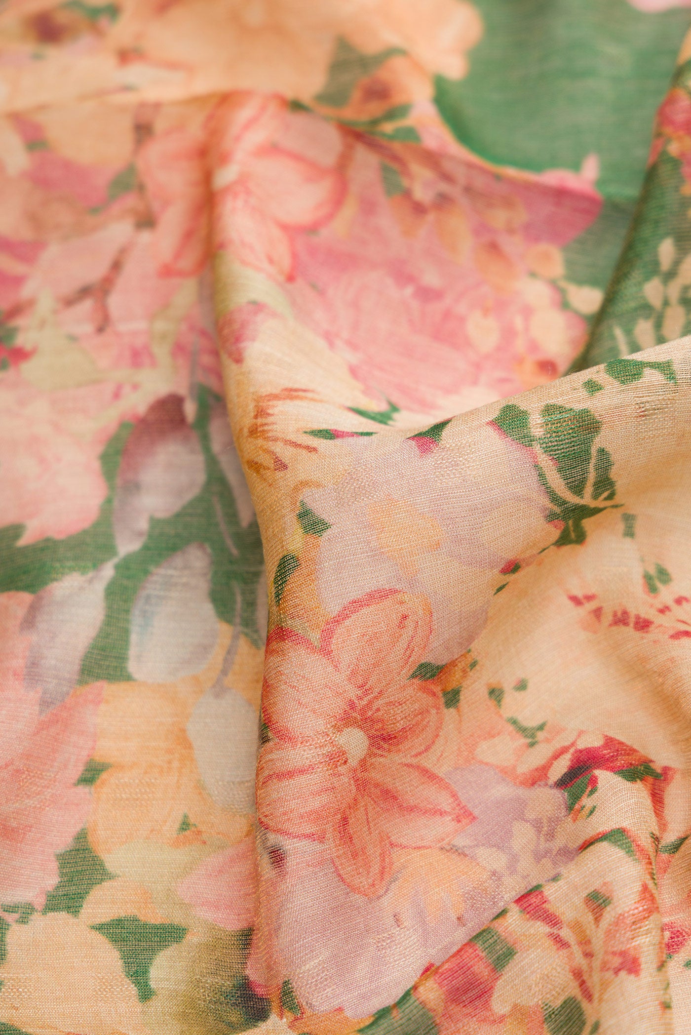 Close up of Green Dual Tone Tussar Silk Saree with Printed design on the body and Embroidery Border.  displaying folds
