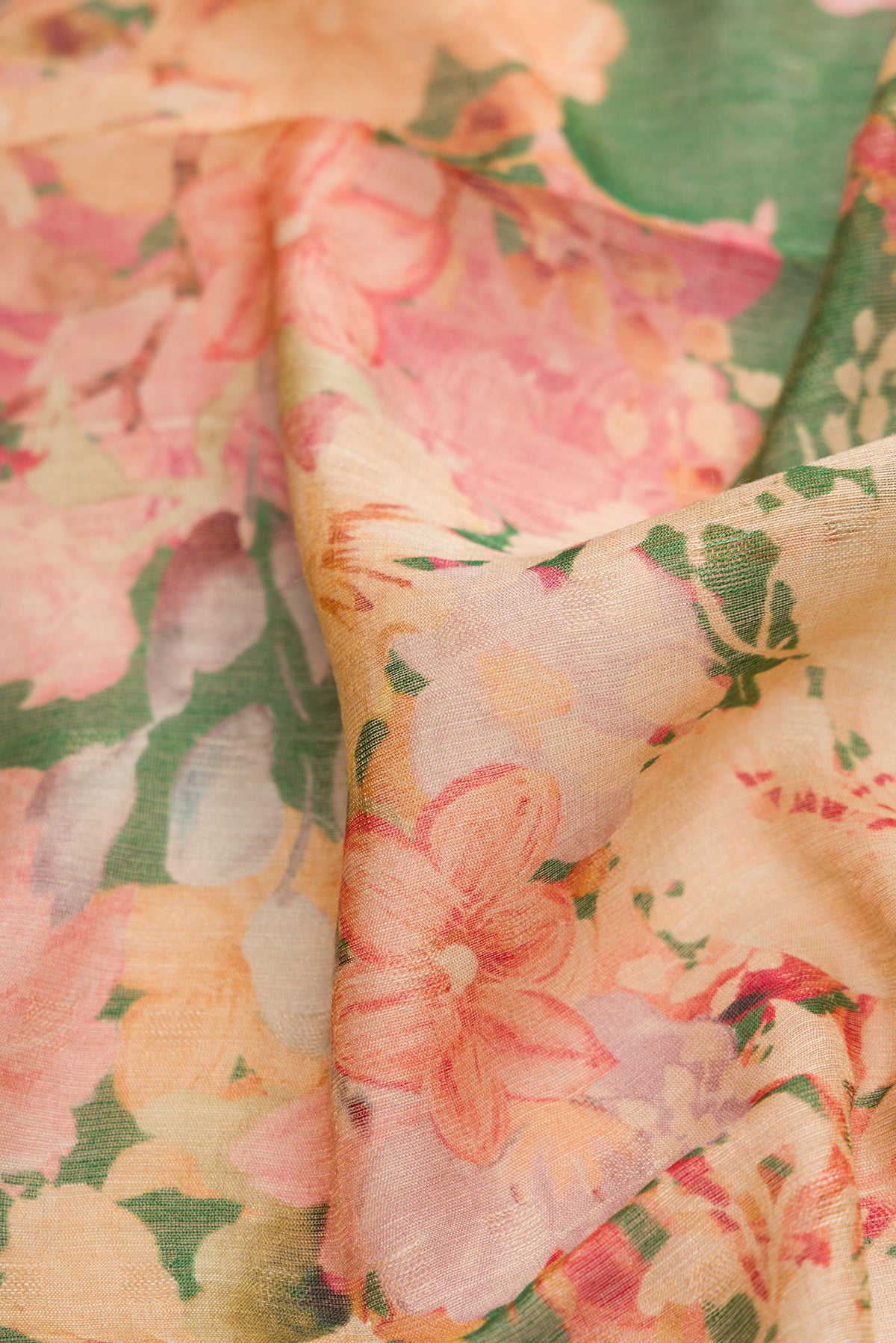 Close up of Green Dual Tone Tussar Silk Saree with Printed design on the body and Embroidery Border.  displaying folds