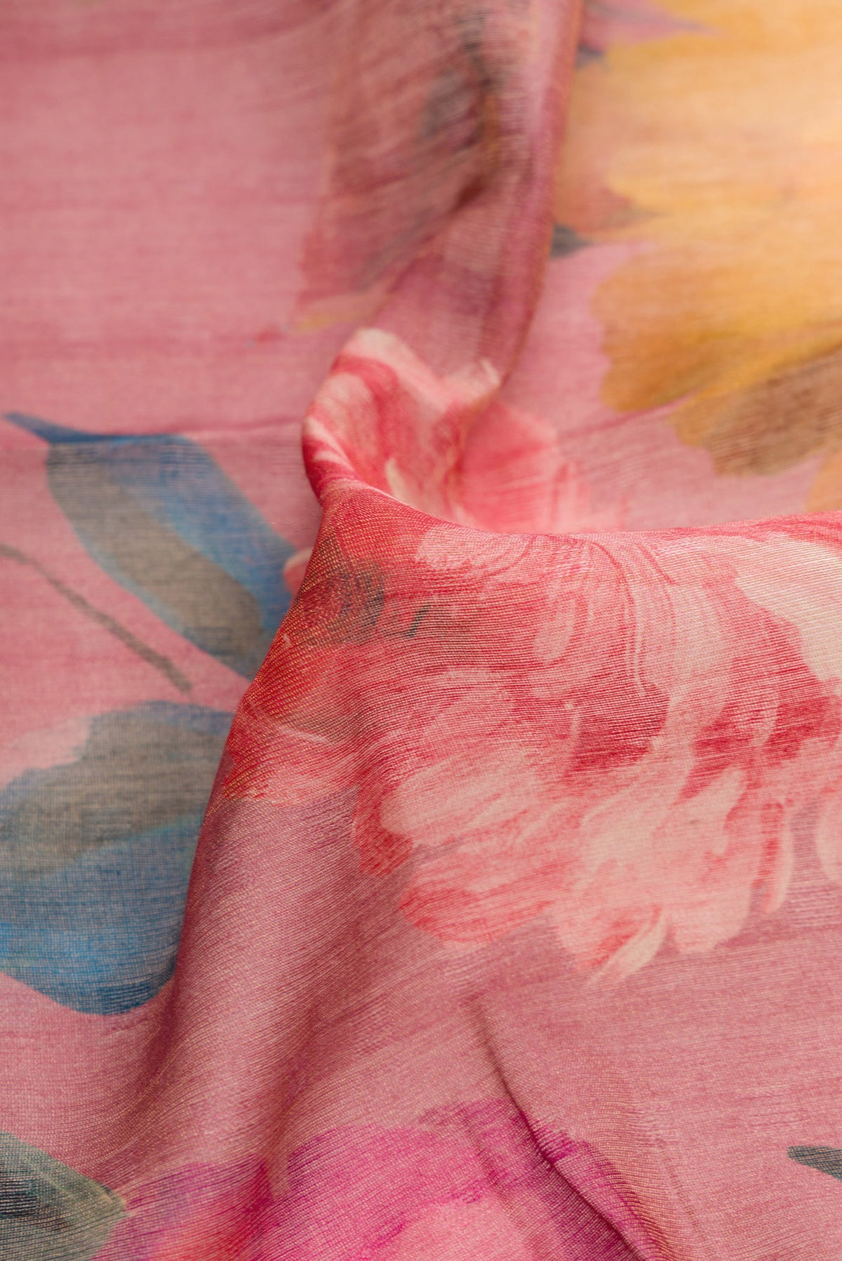 Close up of Rose pink Dual Tone Tussar Silk Saree with Printed design on the body and Embroidery Border.  displaying folds