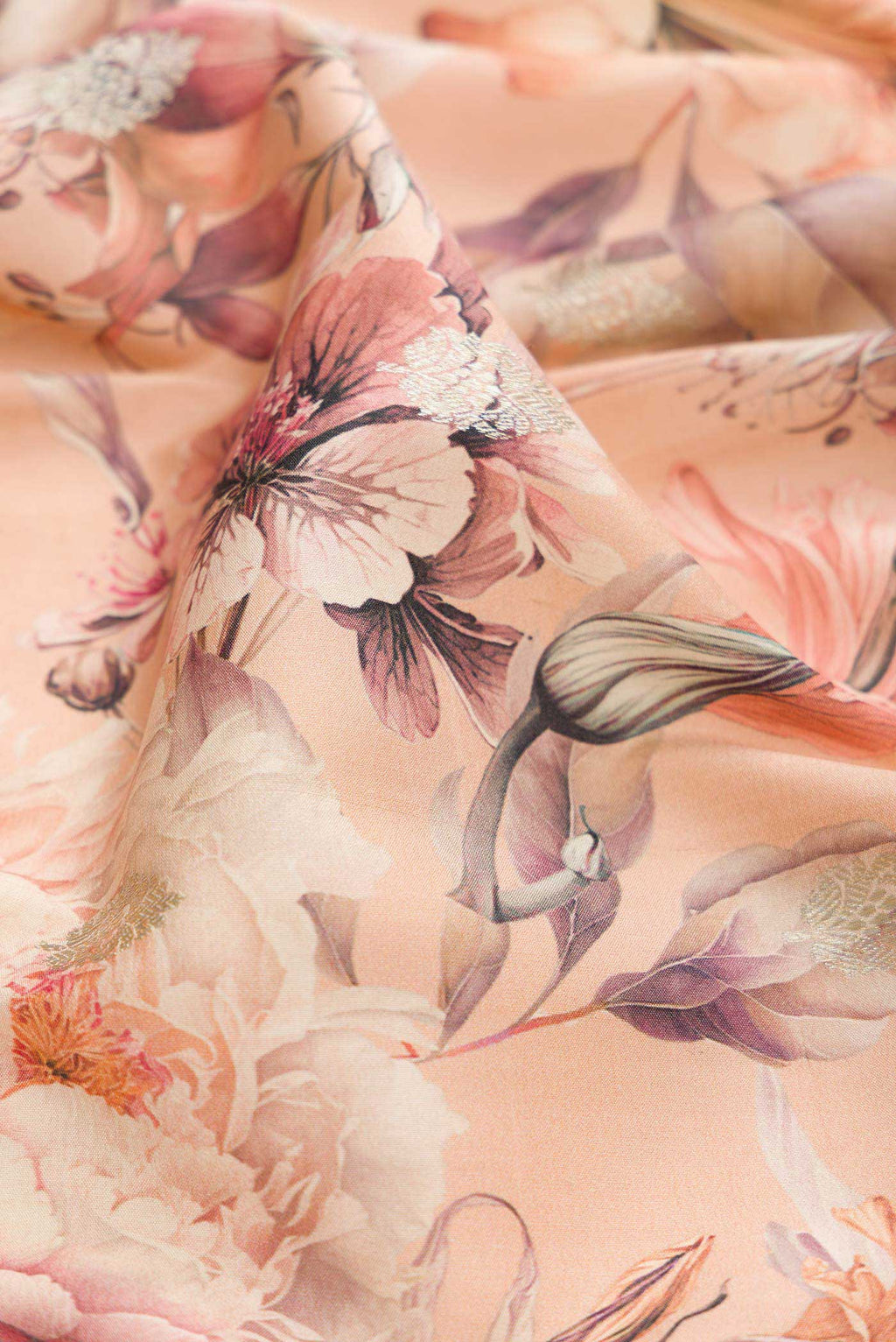 Close up of Peach Dual Tone Tussar Silk Saree with Printed design on the body and Zari Border displaying folds