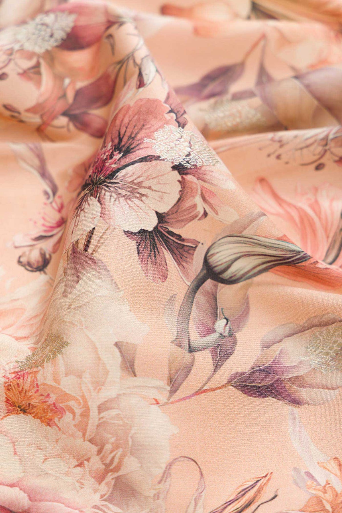 Close up of Peach Dual Tone Tussar Silk Saree with Printed design on the body and Zari Border displaying folds