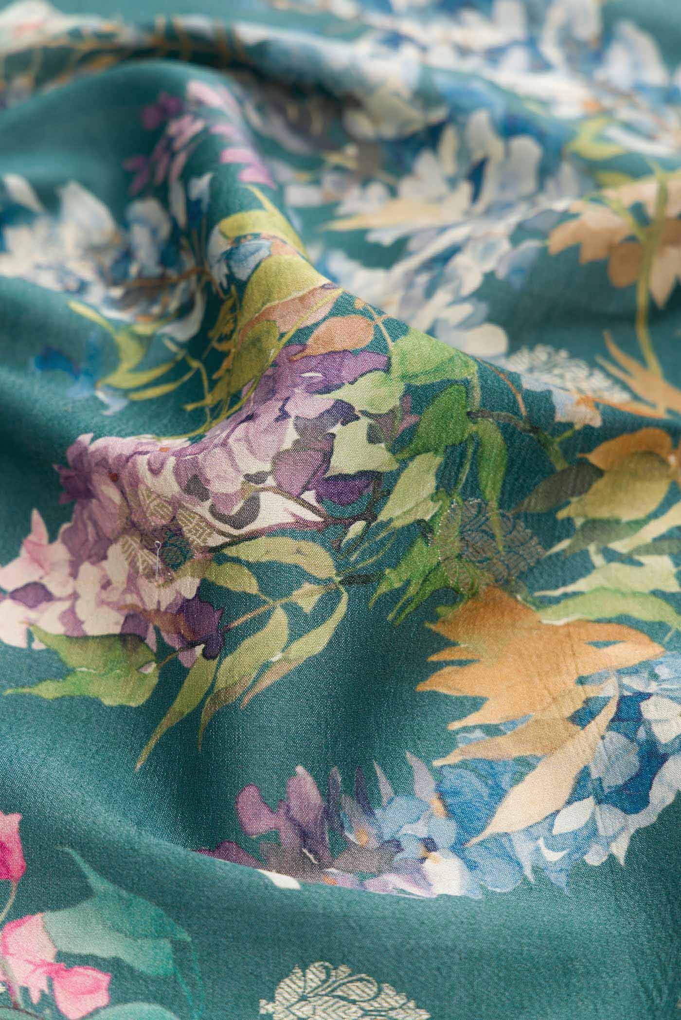 Close up of Blue Tussar Silk Saree with Floral Print on the body and Zari Border displaying folds