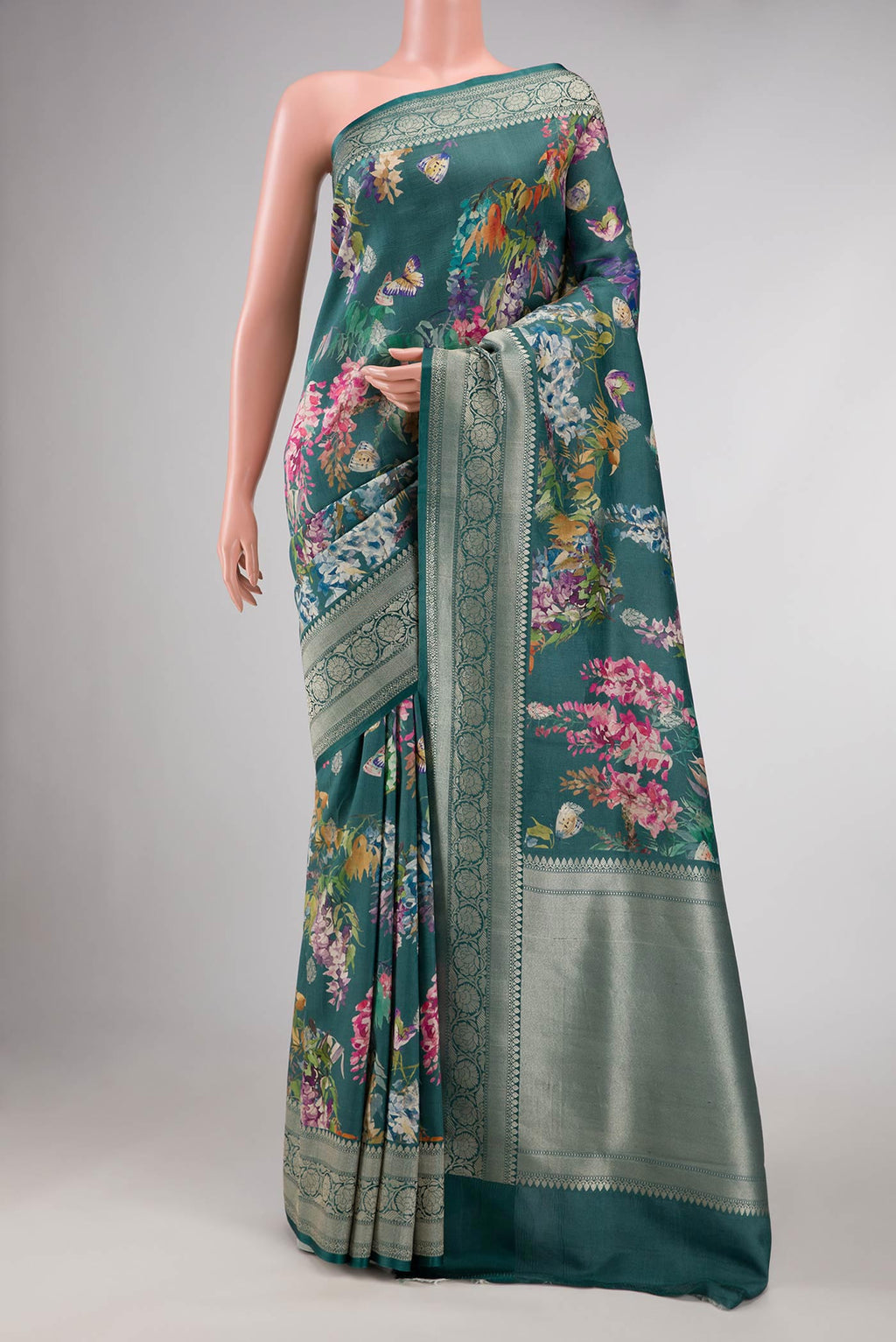 Blue Tussar Silk Saree with Floral Print on the body and Zari Border displayed on a mannequin