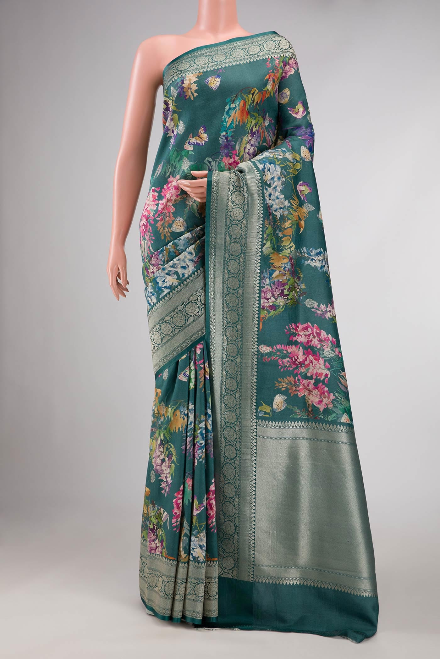 Blue Tussar Silk Saree with Floral Print on the body and Zari Border displayed on a mannequin