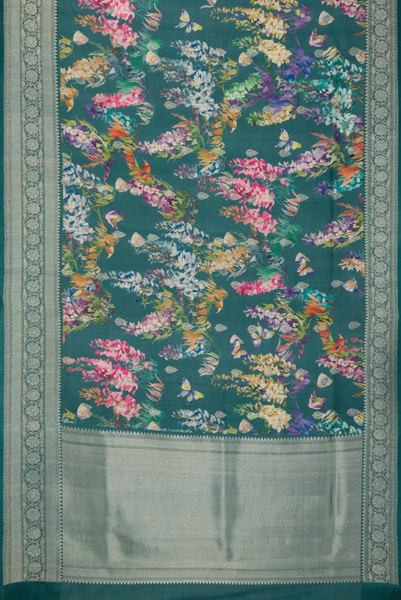 Flat view of Blue Tussar Silk Saree with Floral Print on the body and Zari Border