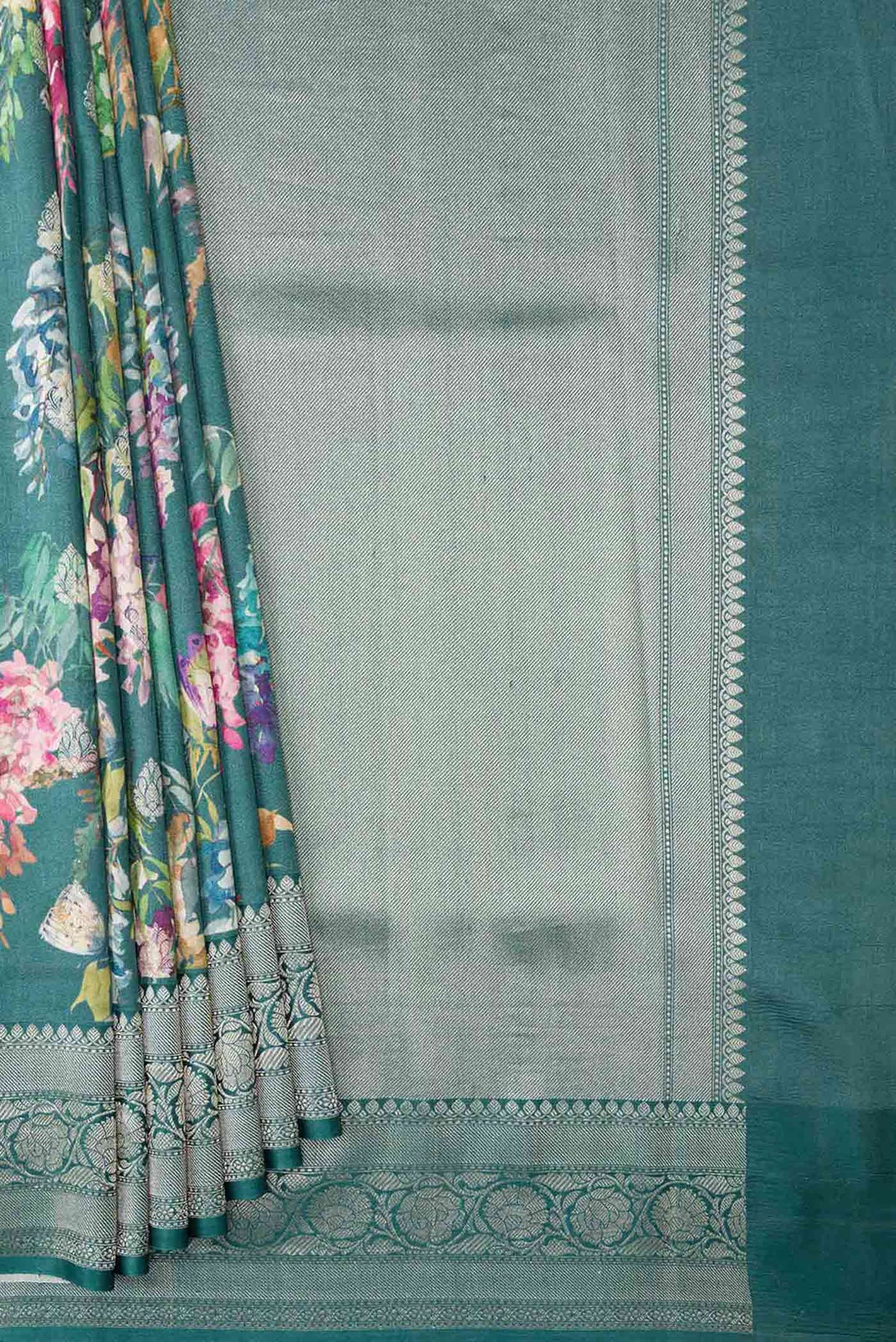 Pleats and pallu of Blue Tussar Silk Saree with Floral Print on the body and Zari Border