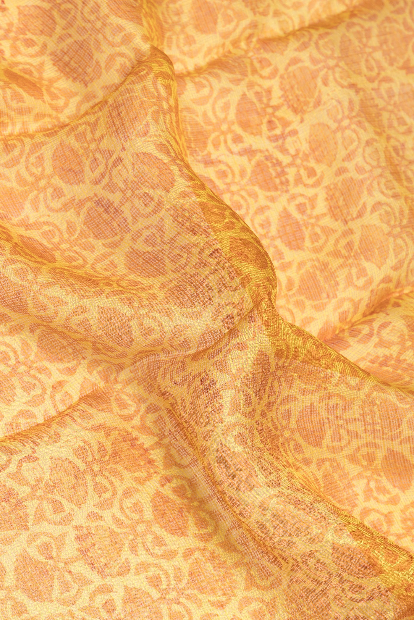 Close up of Yellow Kota Silk Saree with Printed design on the body and Zari Border.  displaying folds