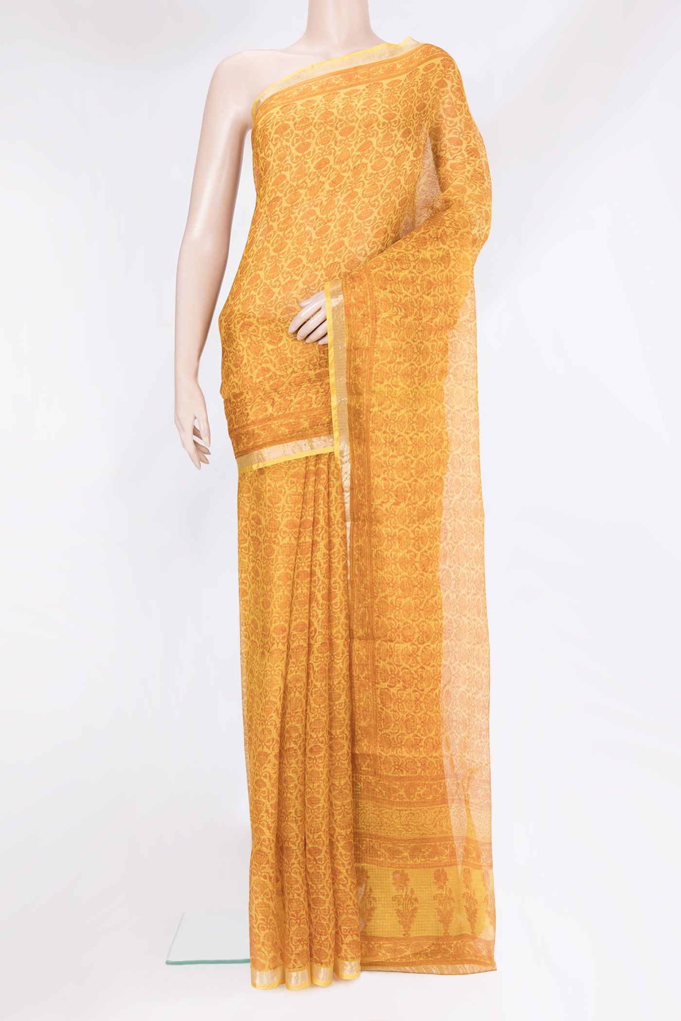 Yellow Kota Silk Saree with Printed design on the body and Zari Border.  displayed on a mannequin