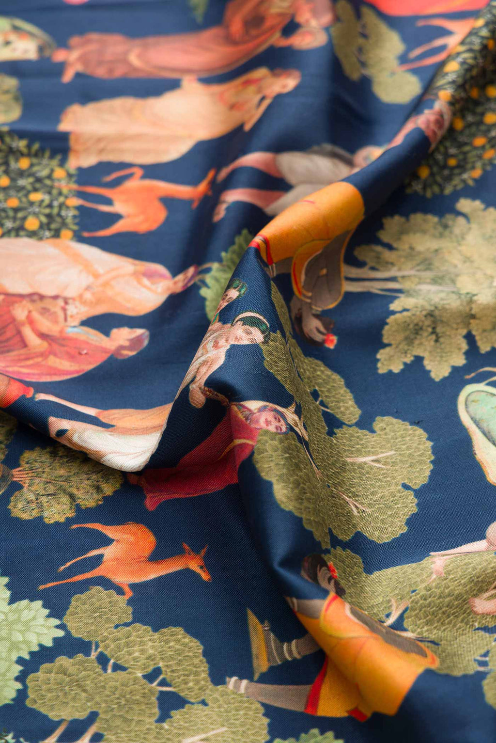 Close up of Navy Blue Dual Tone Kanchipuram Silk Saree with Printed design on the body and Ikat Border displaying folds