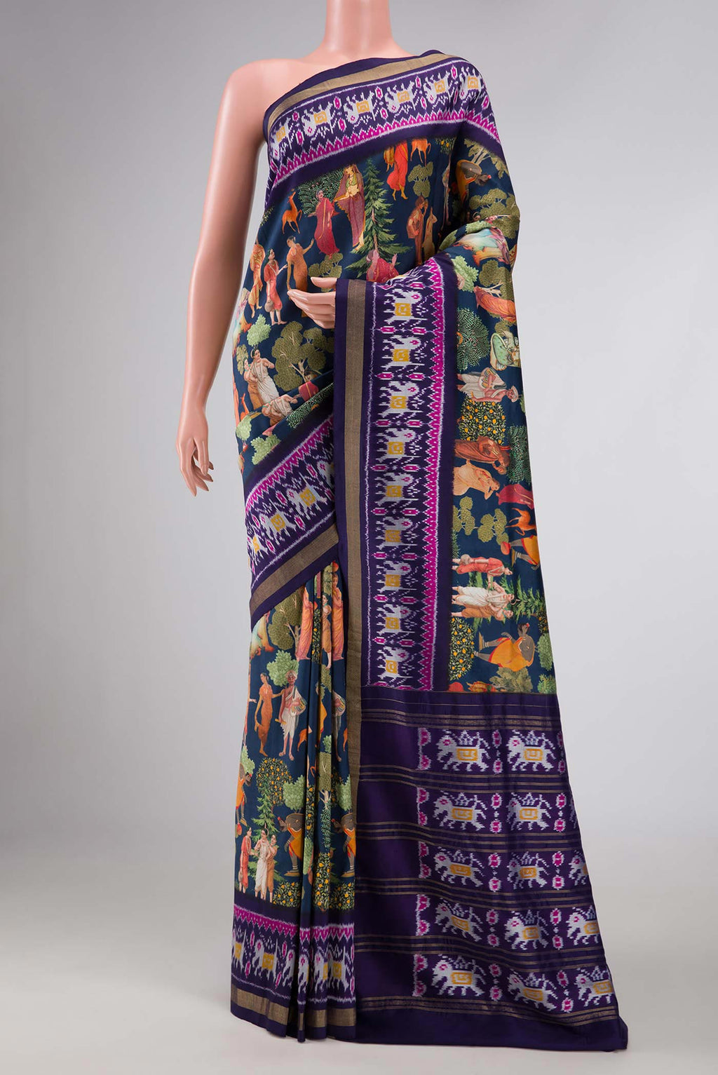 Navy Blue Dual Tone Kanchipuram Silk Saree with Printed design on the body and Ikat Border displayed on a mannequin
