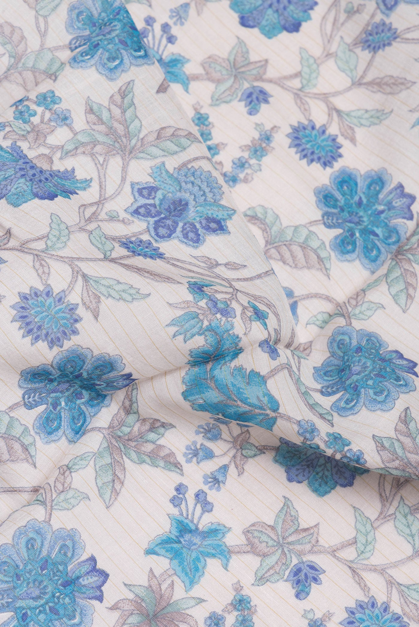 Close up of Beige Chanderi Silk Cotton Saree with Printed design on the body and Zari And Thread Border.  displaying folds