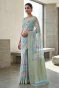 Model wearing a Light Blue Dual Tone Mysore Georgette Saree with Printed design on the body and Zari Border.