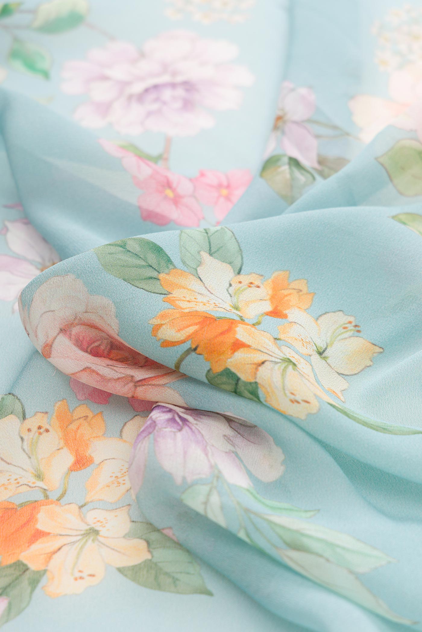Close up of Light Blue Dual Tone Mysore Georgette Saree with Printed design on the body and Zari Border displaying folds