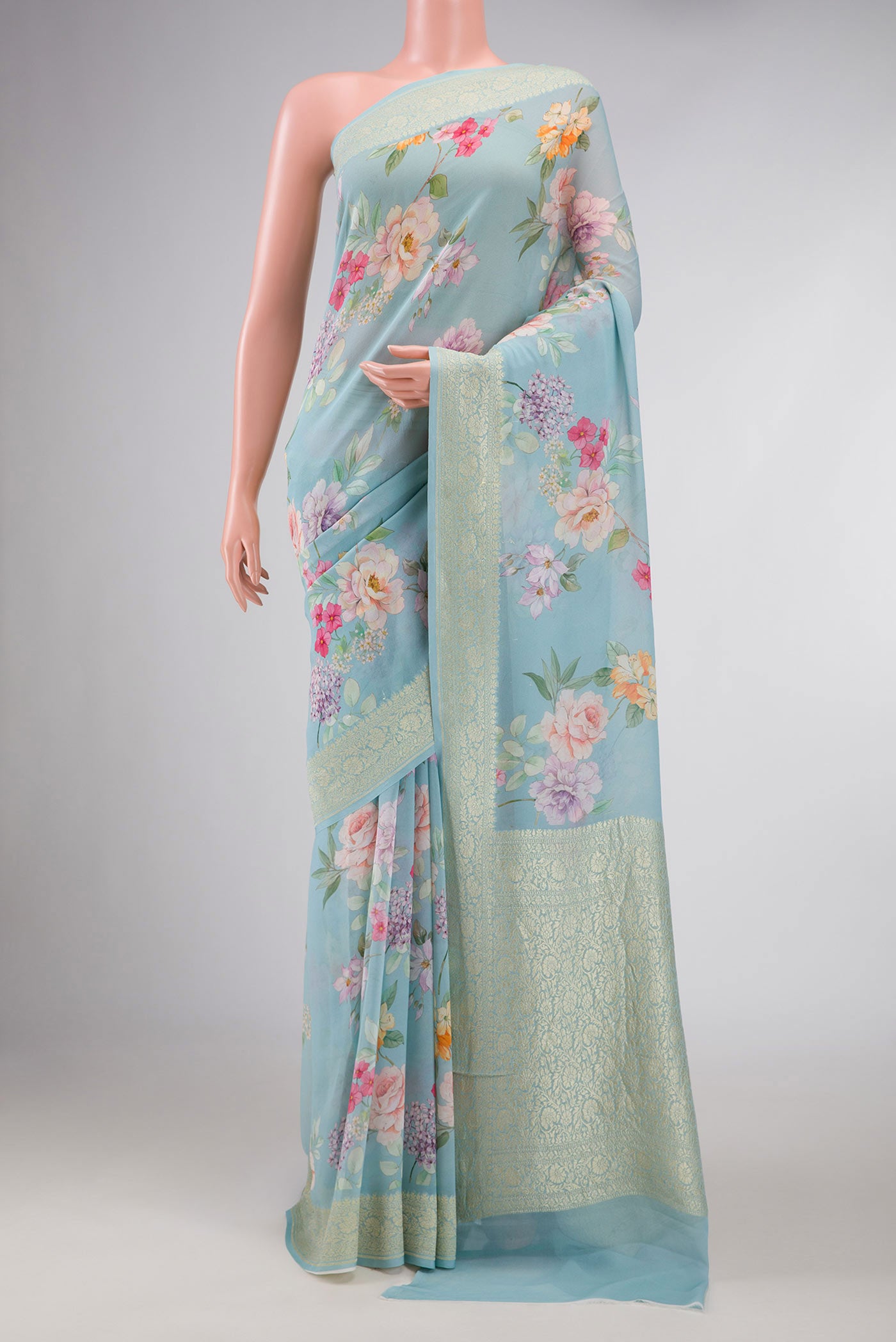 Light Blue Dual Tone Mysore Georgette Saree with Printed design on the body and Zari Border displayed on a mannequin