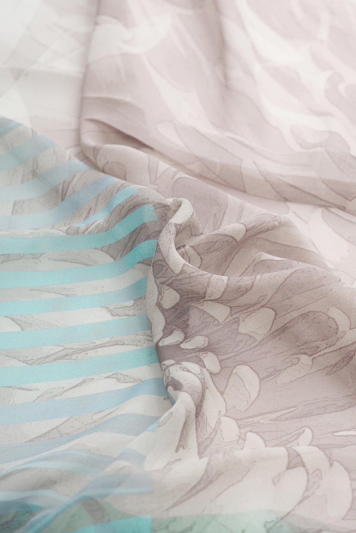 Close up of Grey Dual Tone Mysore Georgette SareePrinted design on the body and Without Border displaying folds
