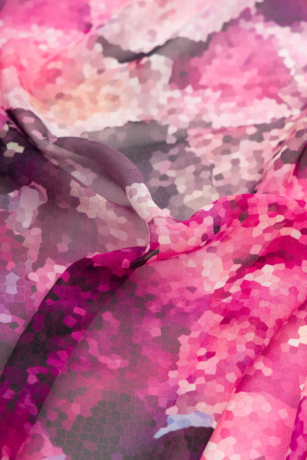 Close up of Pink Dual Tone Mysore Georgette Saree with Printed design on the body and Plain Border displaying folds