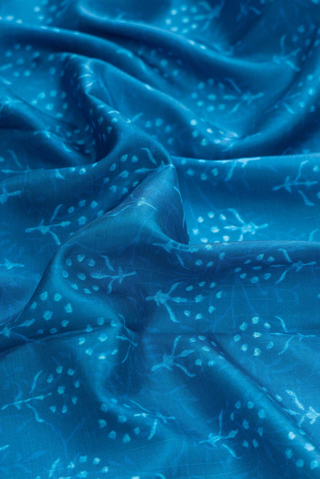 Close up of Blue Dual Tone Kanchipuram Silk Saree with Printed design on the body and Zari Border displaying folds