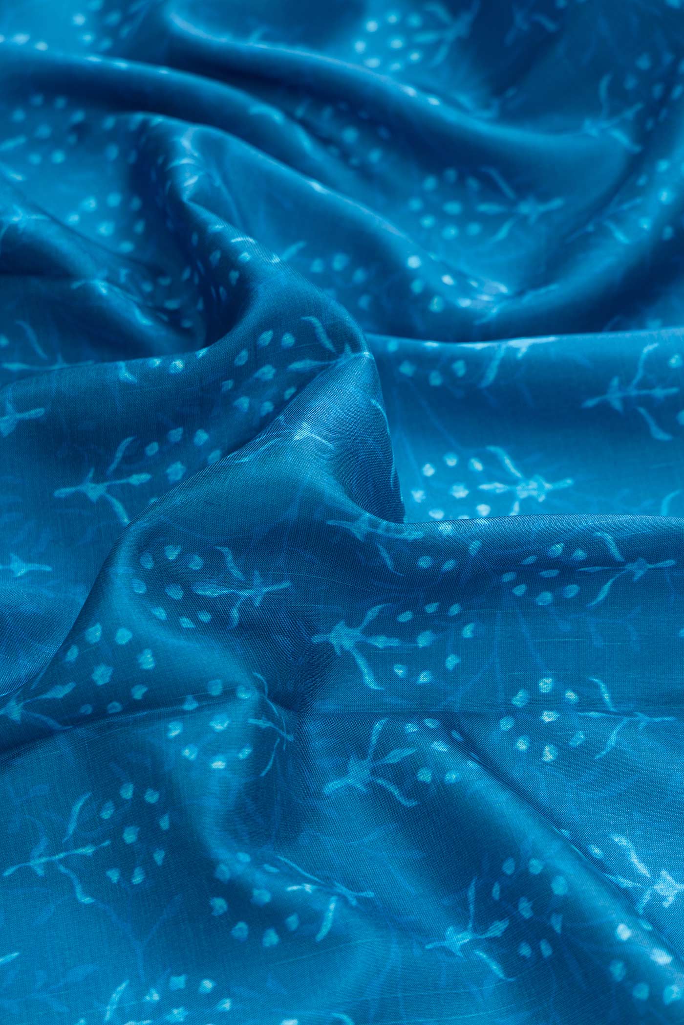 Close up of Blue Dual Tone Kanchipuram Silk Saree with Printed design on the body and Zari Border displaying folds