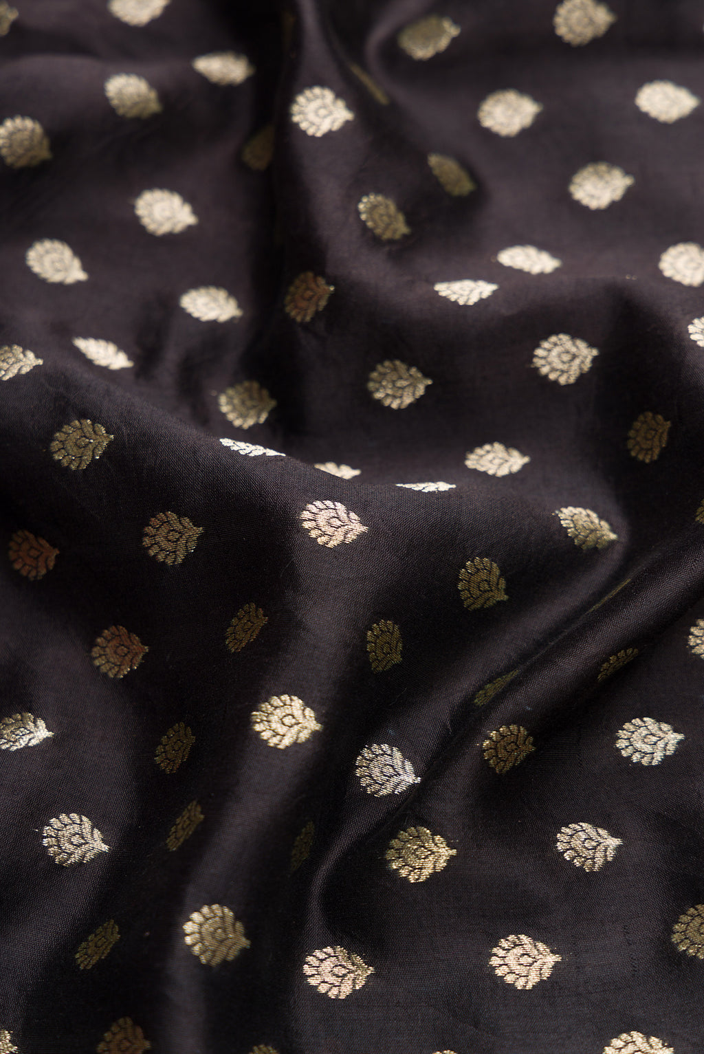 Close up of Black Dual Tone Tussar Silk Saree with Zari Butta on the body and Without Border.  displaying folds
