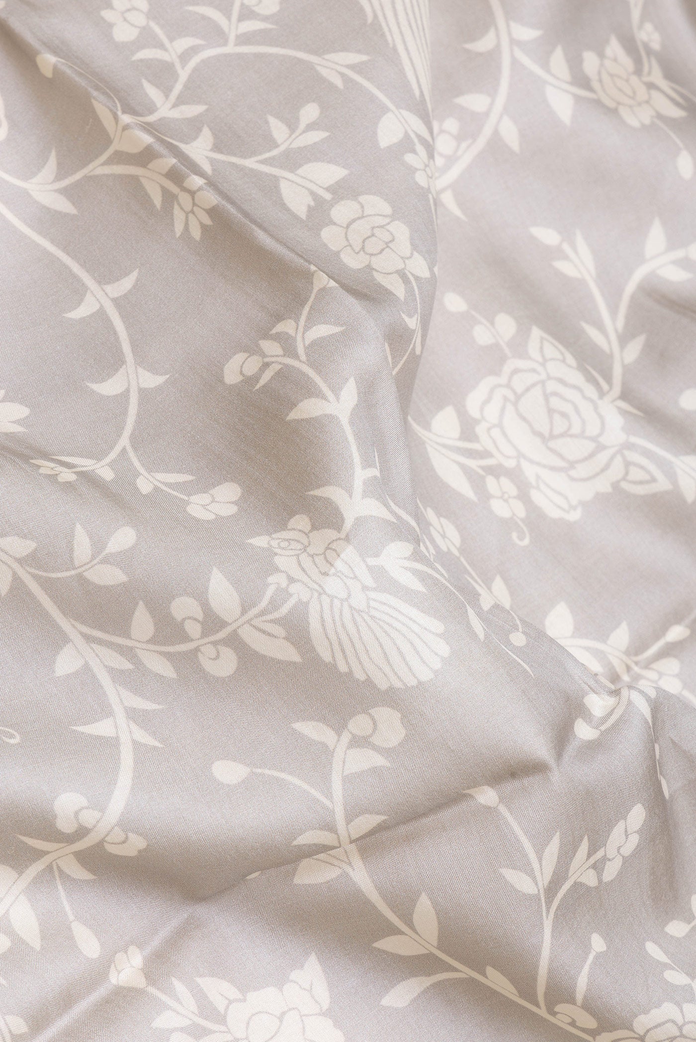 Close up of Grey Tussar Silk Saree with Printed design on the body and Printed Border.  displaying folds