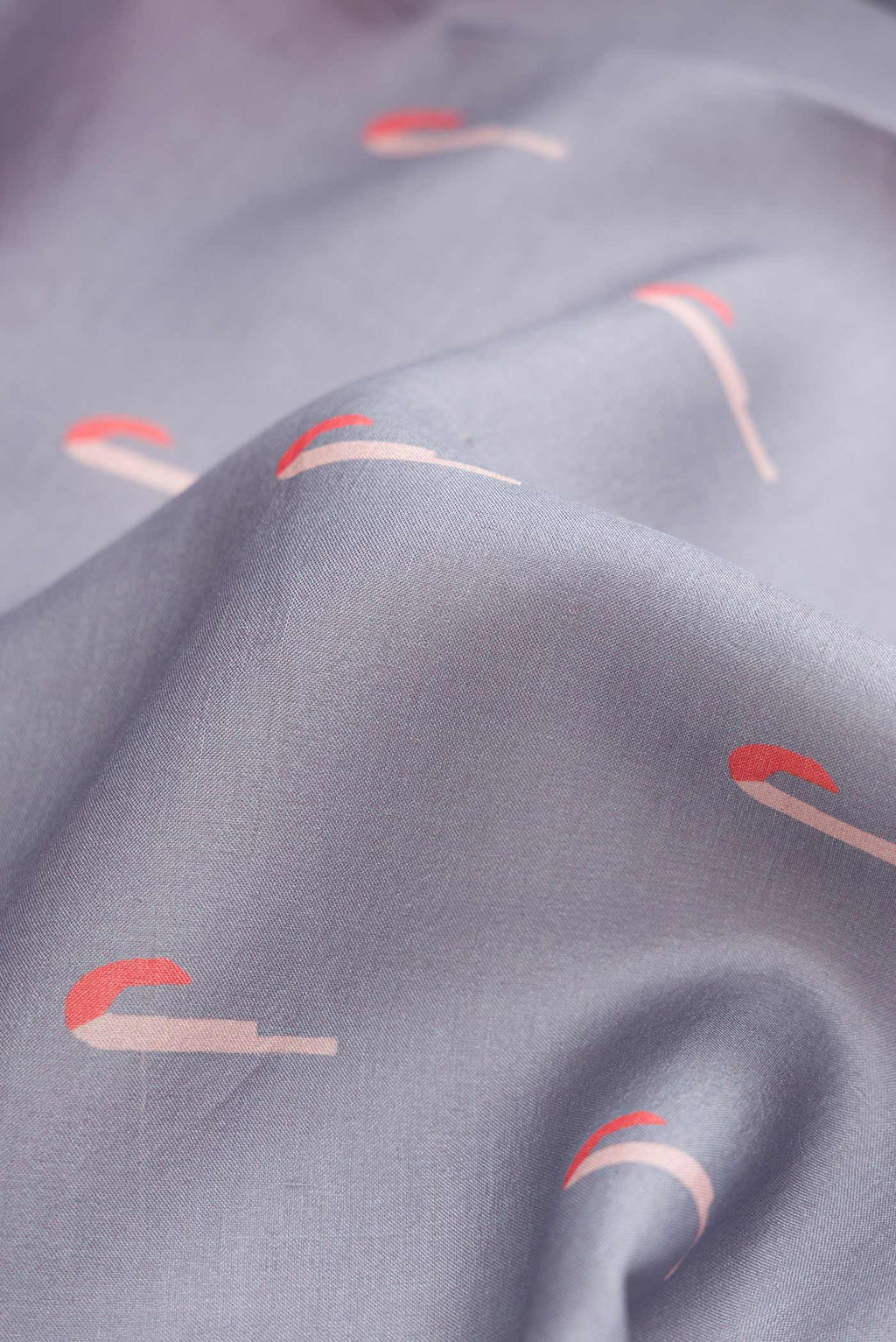 Close up of Grey Dual Tone Tussar Silk Saree with Thread Butta on the body and Thread Border displaying folds