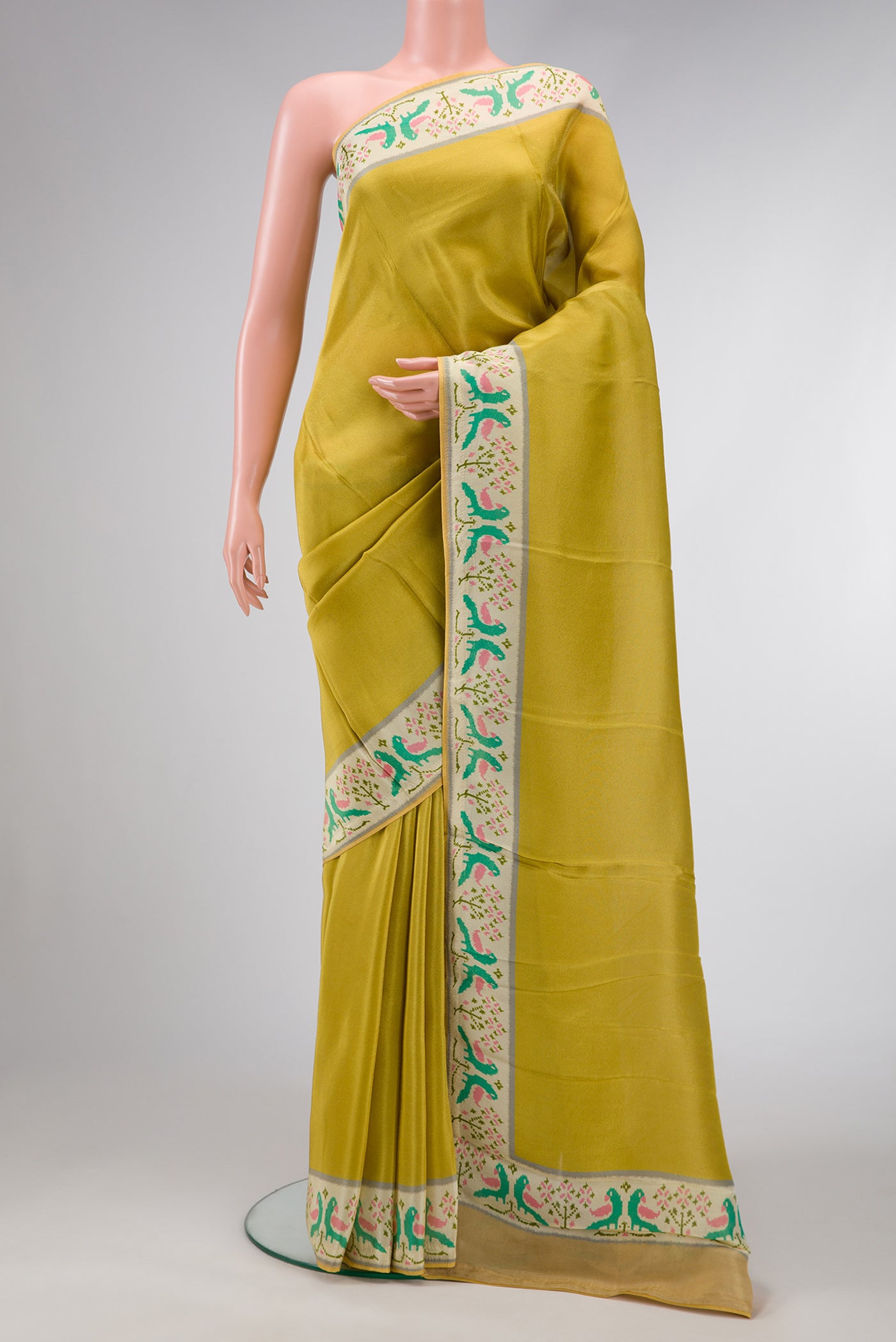 Parrot Green Dual Tone Mysore Georgette Saree with Plain Body and Fancy Border.  displayed on a mannequin