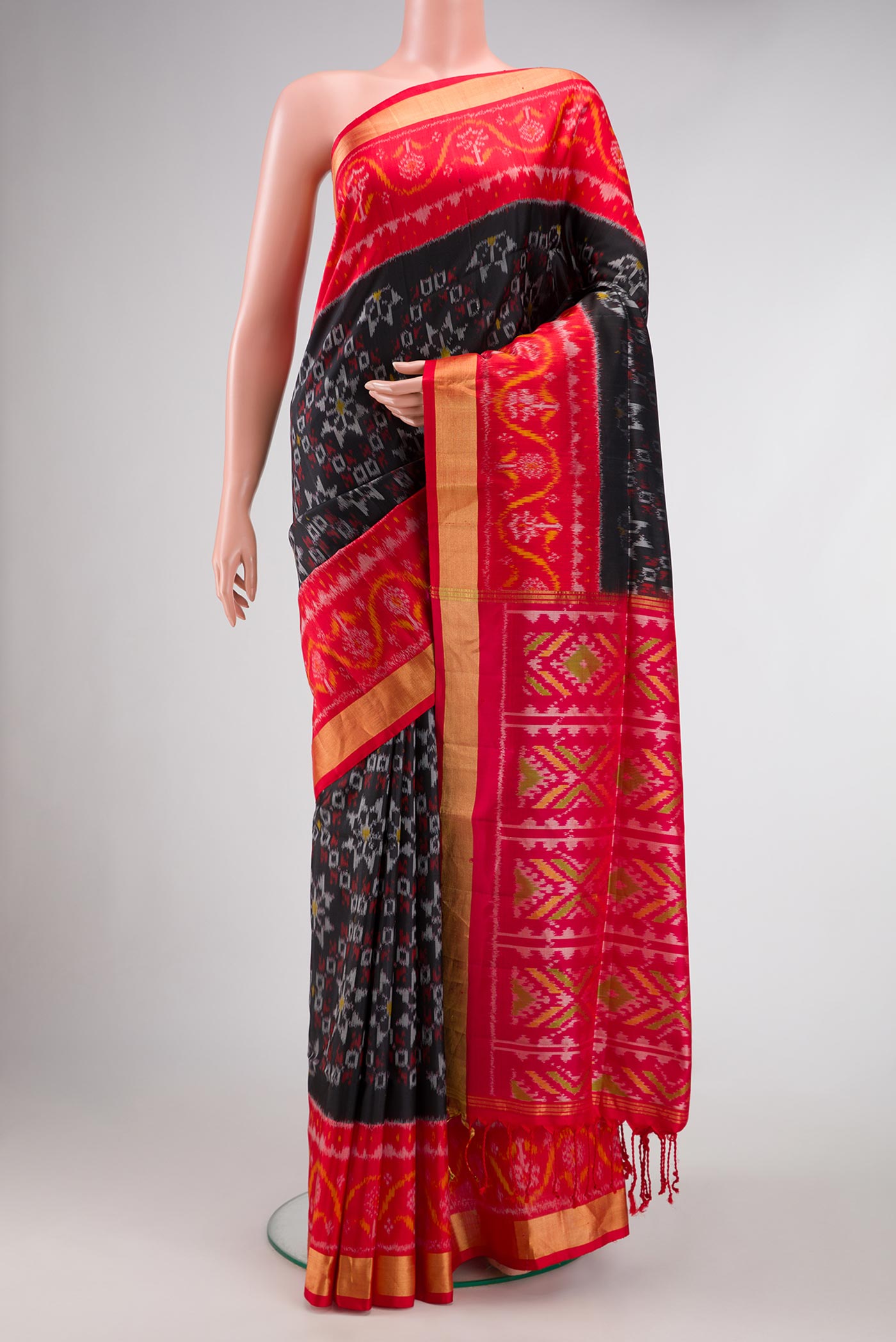 Black Dual Tone Soft Silk Saree with Ikat Print on the body and Ikat Border.  displayed on a mannequin