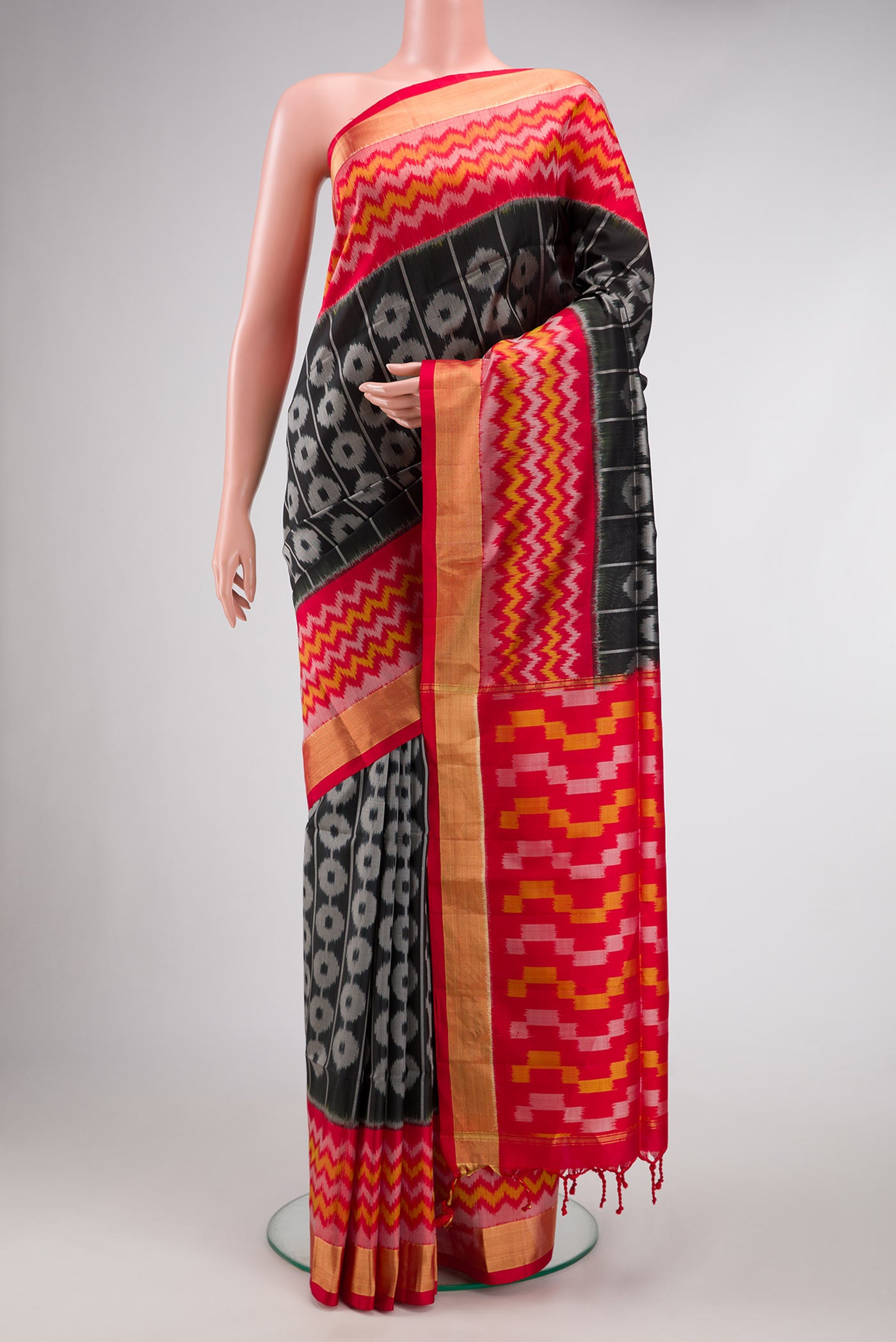 Black Dual Tone Soft Silk Saree with Ikat Print on the body and Ikat Border.  displayed on a mannequin