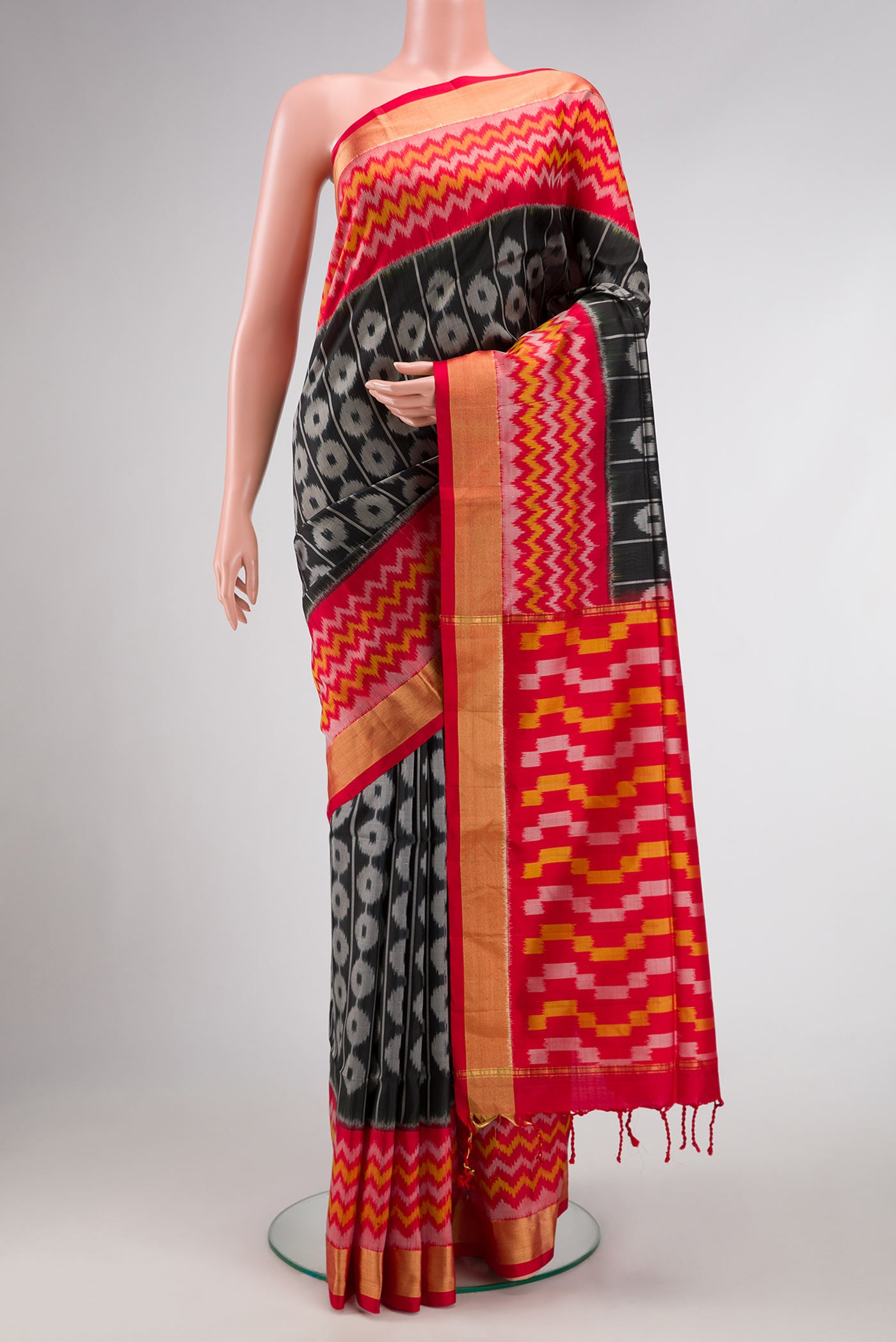 Black Dual Tone Soft Silk Saree with Ikat Print on the body and Ikat Border.  displayed on a mannequin