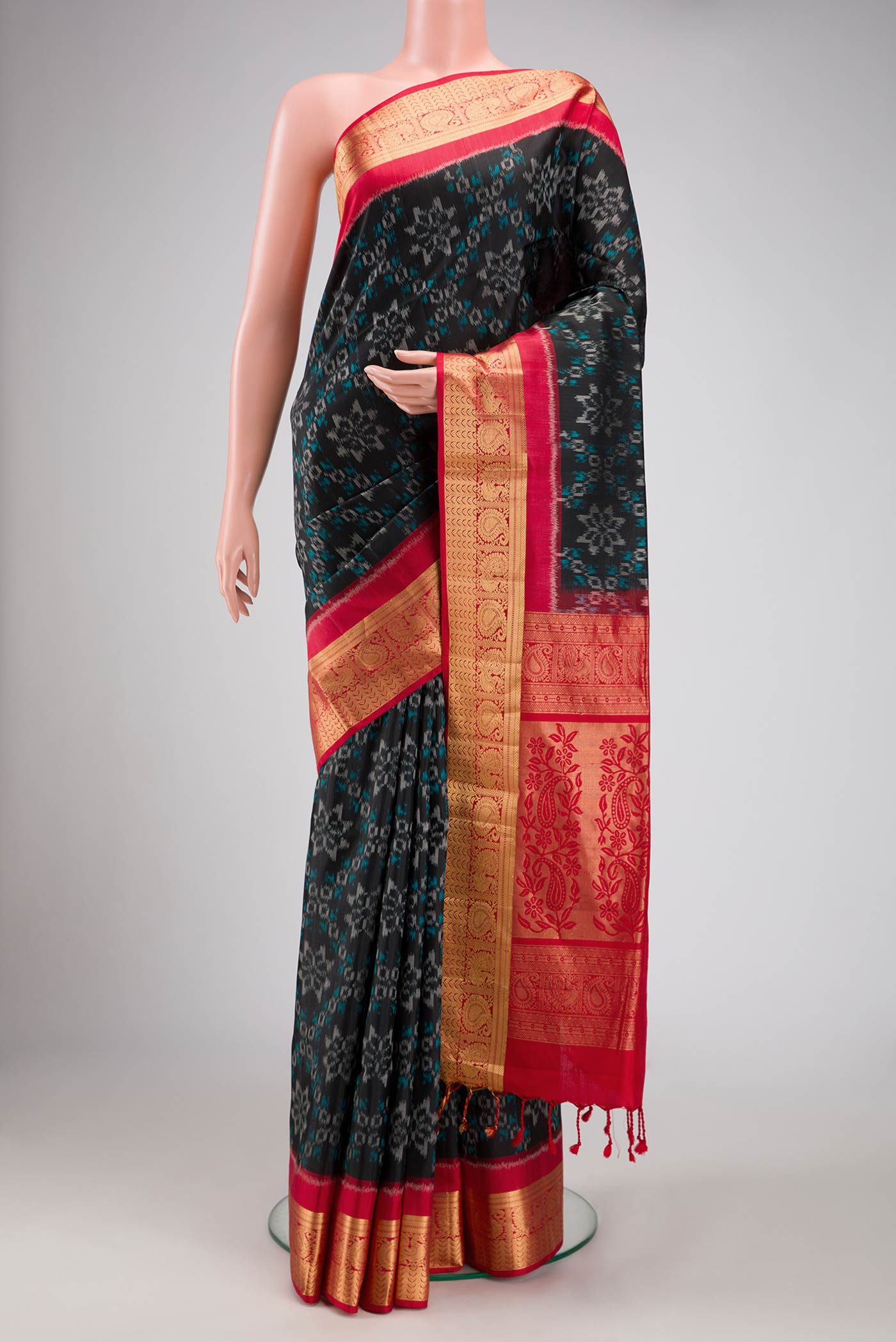 Black Dual Tone Soft Silk Saree with Ikat Print on the body and Zari Border.  displayed on a mannequin