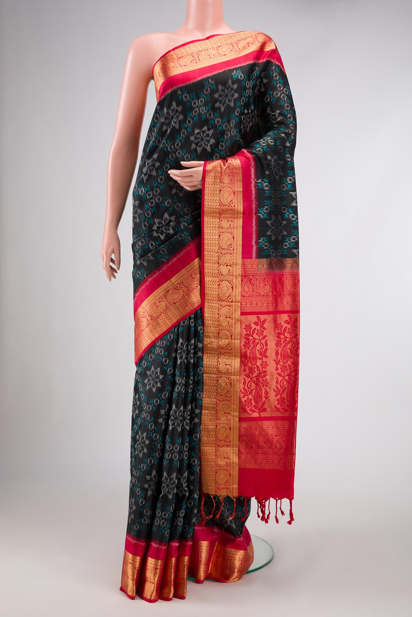 Black Dual Tone Soft Silk Saree with Ikat Print on the body and Zari Border.  displayed on a mannequin