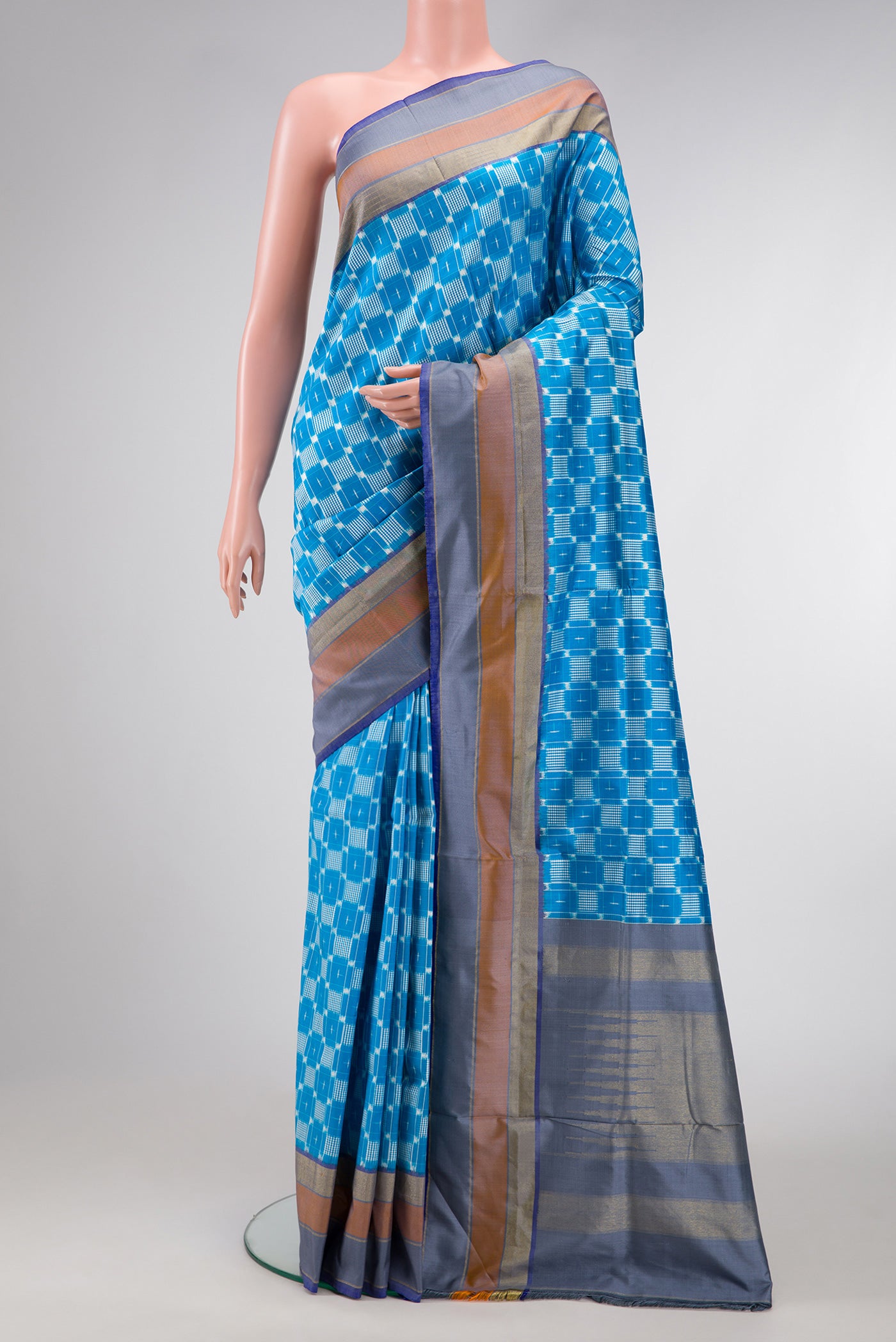 Sky Blue Dual Tone Double Ikat Saree with Ikat Print on the body and Zari Border.  displayed on a mannequin