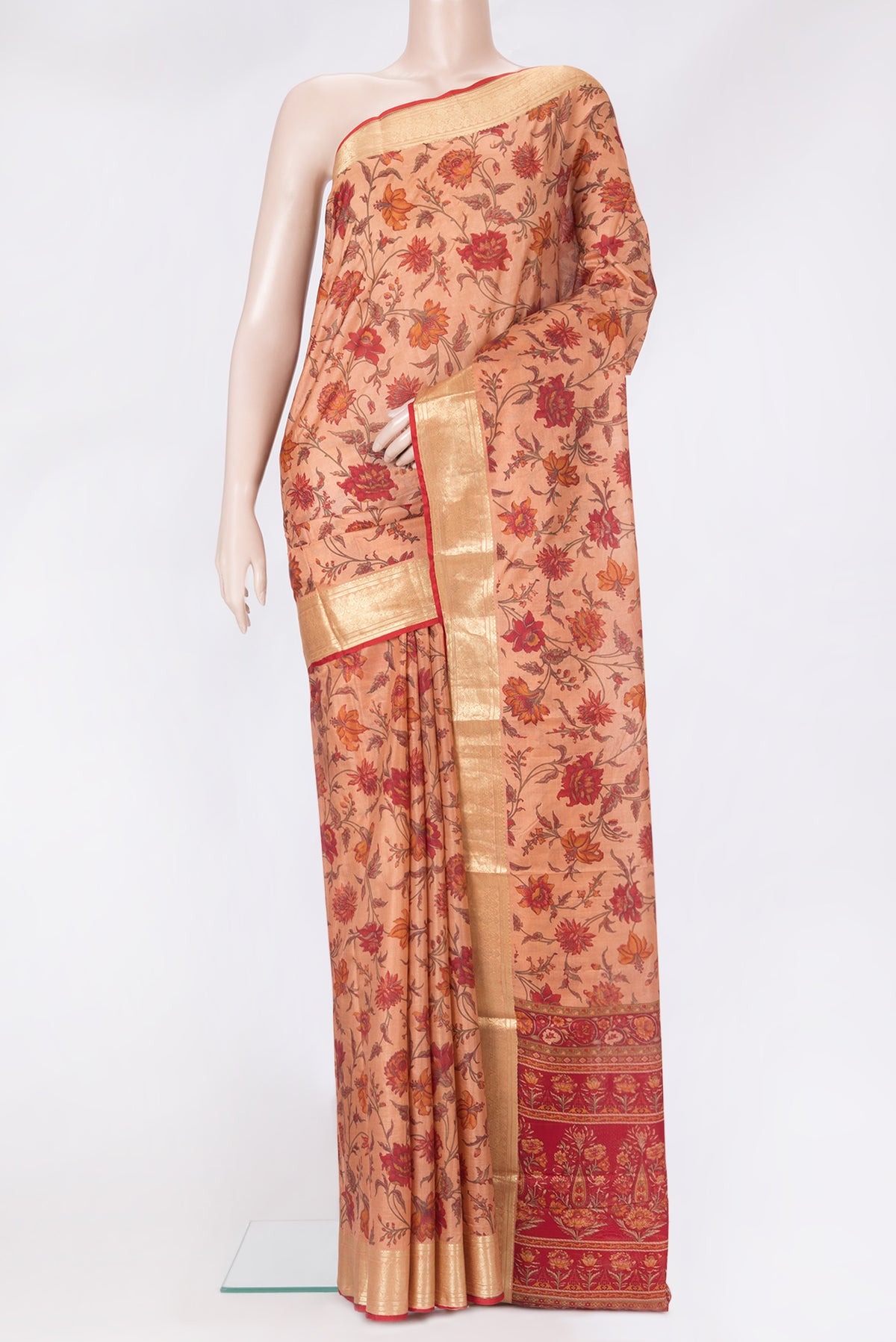 Peach Printed Silk Saree with Printed design on the body and Zari Border.  displayed on a mannequin