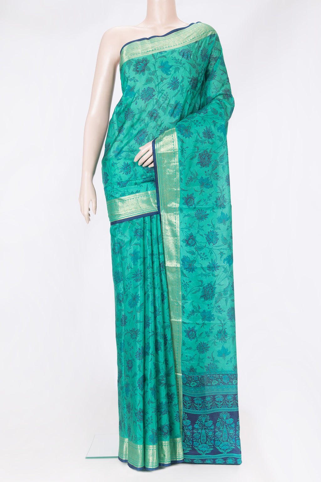 Teal Printed Silk Saree with Printed design on the body and Zari Border.  displayed on a mannequin