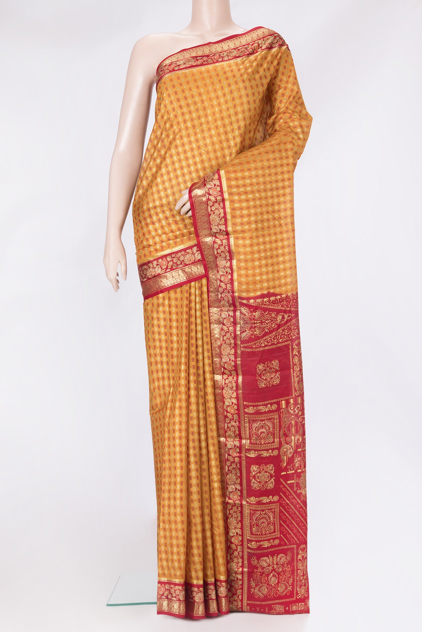 Mustard Printed Silk Saree with Printed design on the body and Zari Border.  displayed on a mannequin